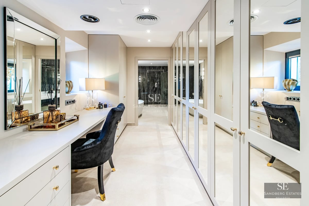 Spacious terrace with infinity pool, sun loungers, and panoramic sea views. Modern, elegant design with lush greenery.