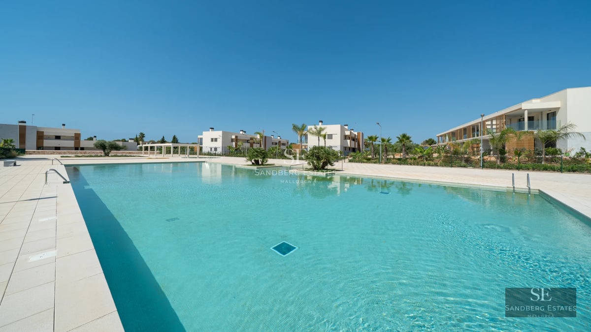 Spacious terrace with infinity pool, lounge chairs, and panoramic views. Modern design with soft ambient lighting and lush vegetation.