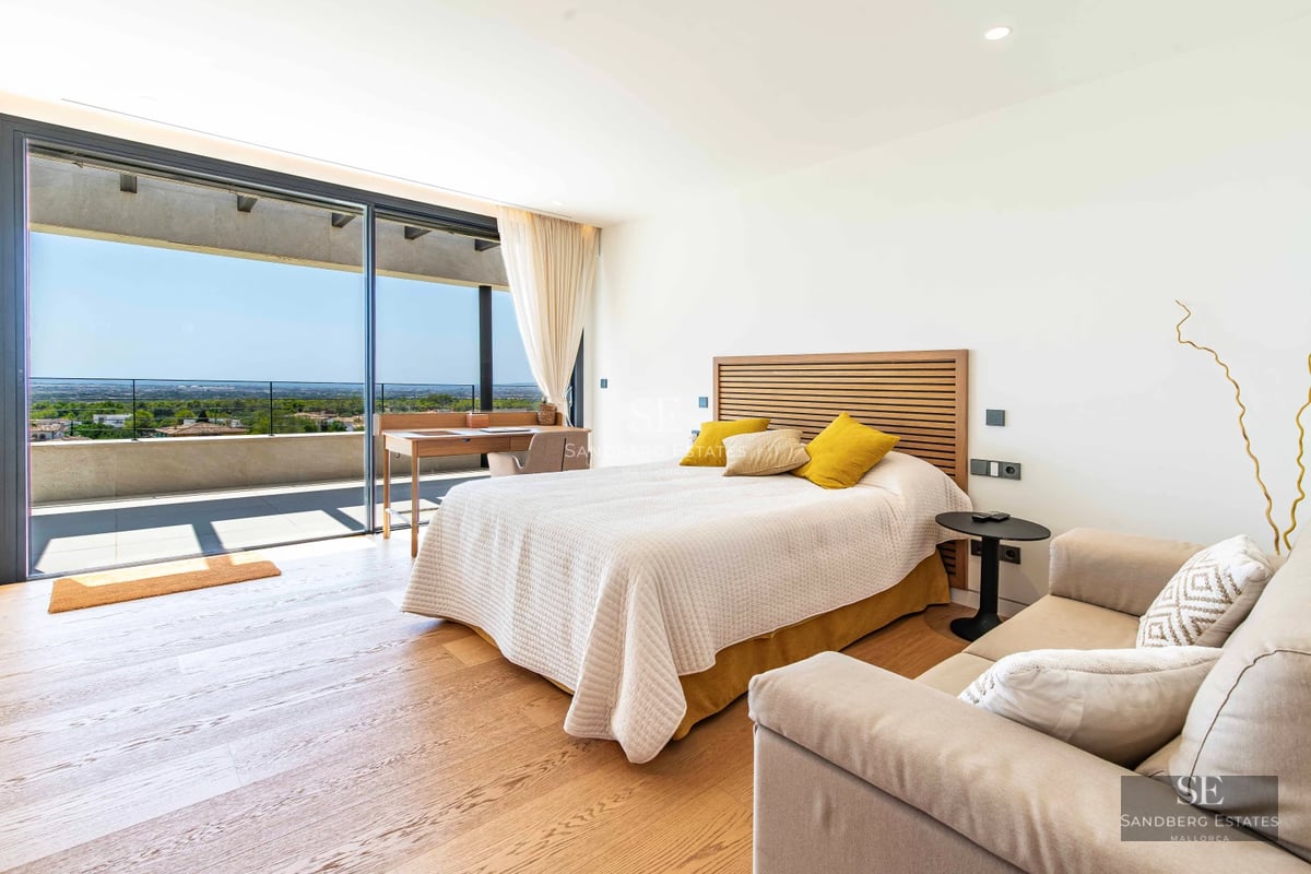 Expansive terrace featuring an infinity pool and panoramic views. Modern architecture with glass railings and elegant furniture.