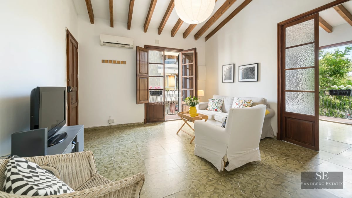 View of a modern villa with a pool, minimalist architecture, and large windows overlooking a lush garden.