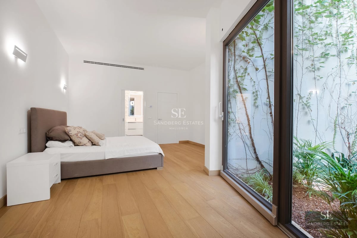 Spacious terrace with infinity pool and sea view. Modern design with elegant outdoor furniture. Soft ambient lighting.