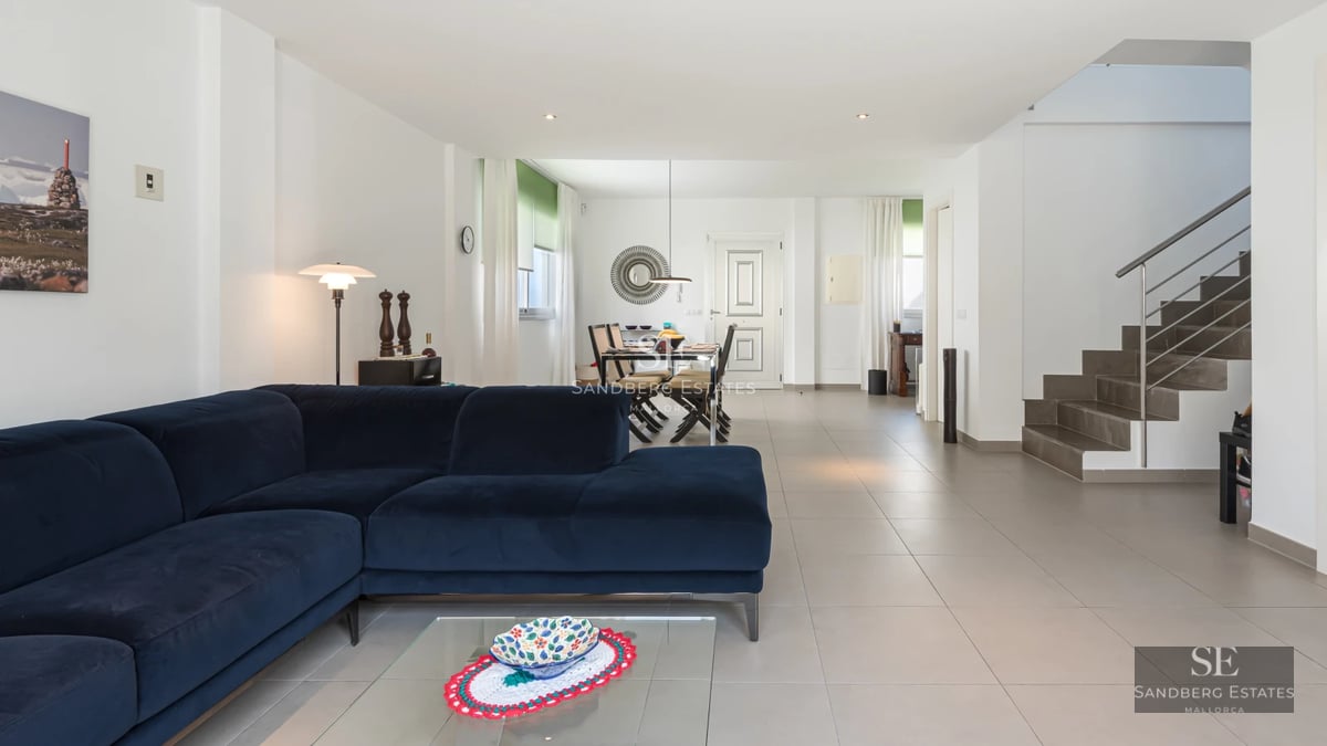 Expansive living room with large windows, pool, and garden. Modern design, natural light, and high-quality finishes.