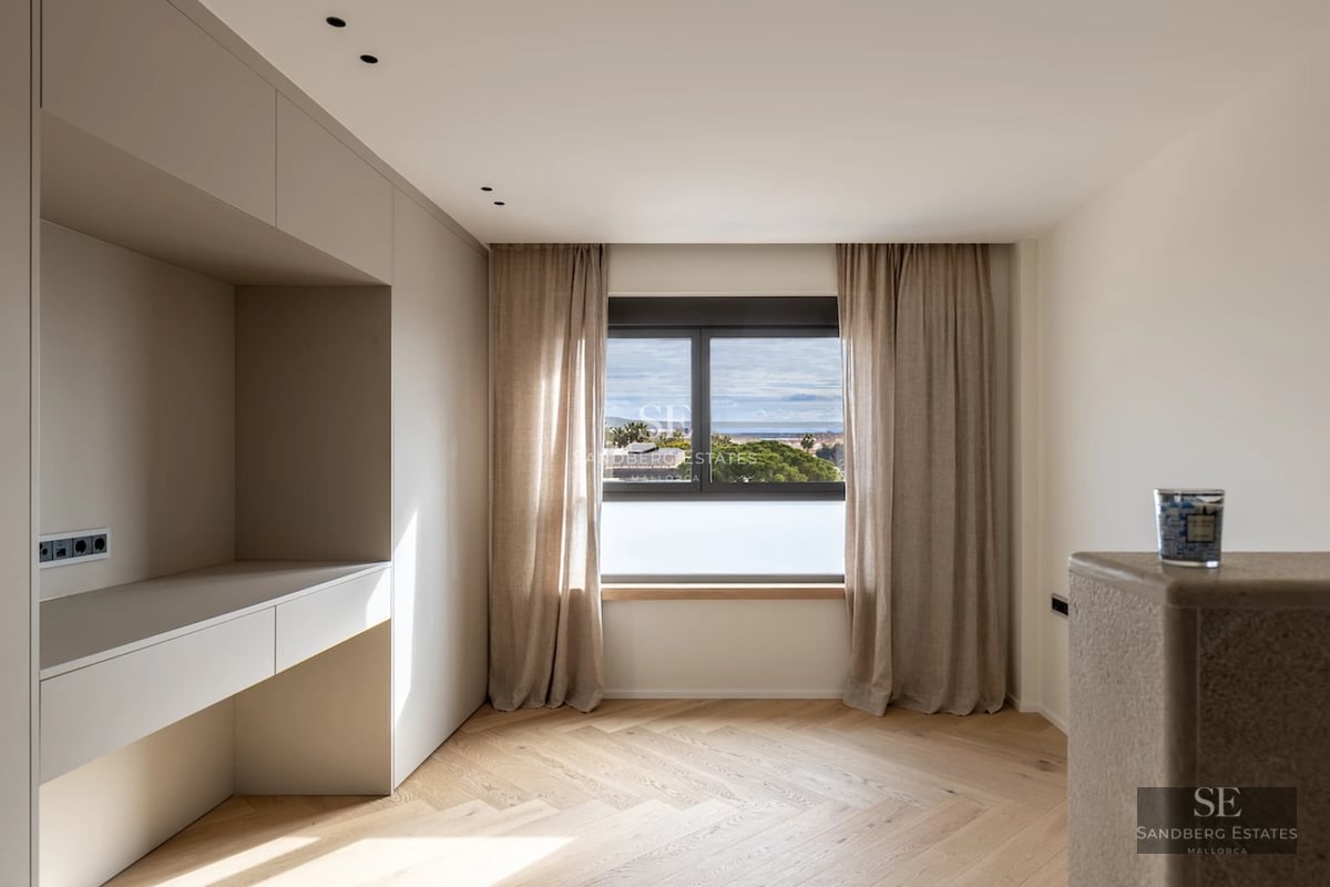 View of a modern villa with a pool, large windows, a terrace, and a lush garden. Clean and elegant architectural design.