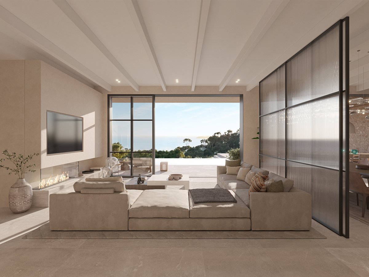 Salon spacieux avec canapé modulaire et baies vitrées toute hauteur ouvrant sur une terrasse et vue mer.