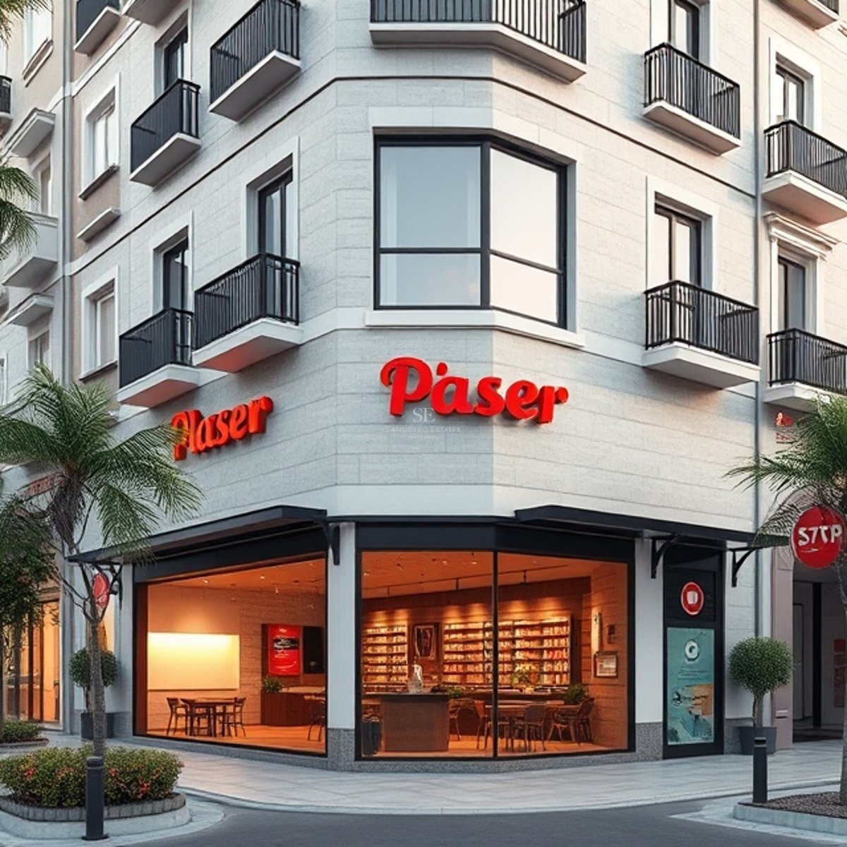 Immeuble d'angle contemporain avec façade en pierre, grandes vitrines et balcons noirs minimalistes.