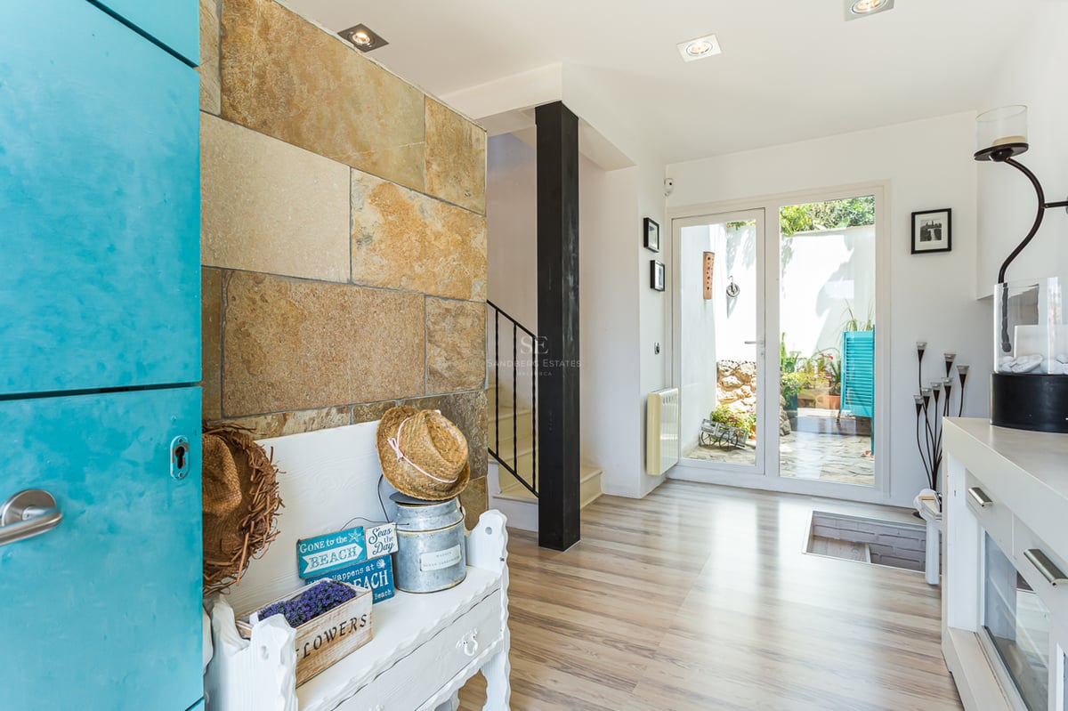 Exterior view of a modern villa with a pool, surrounded by lush greenery and a minimalist architectural design.