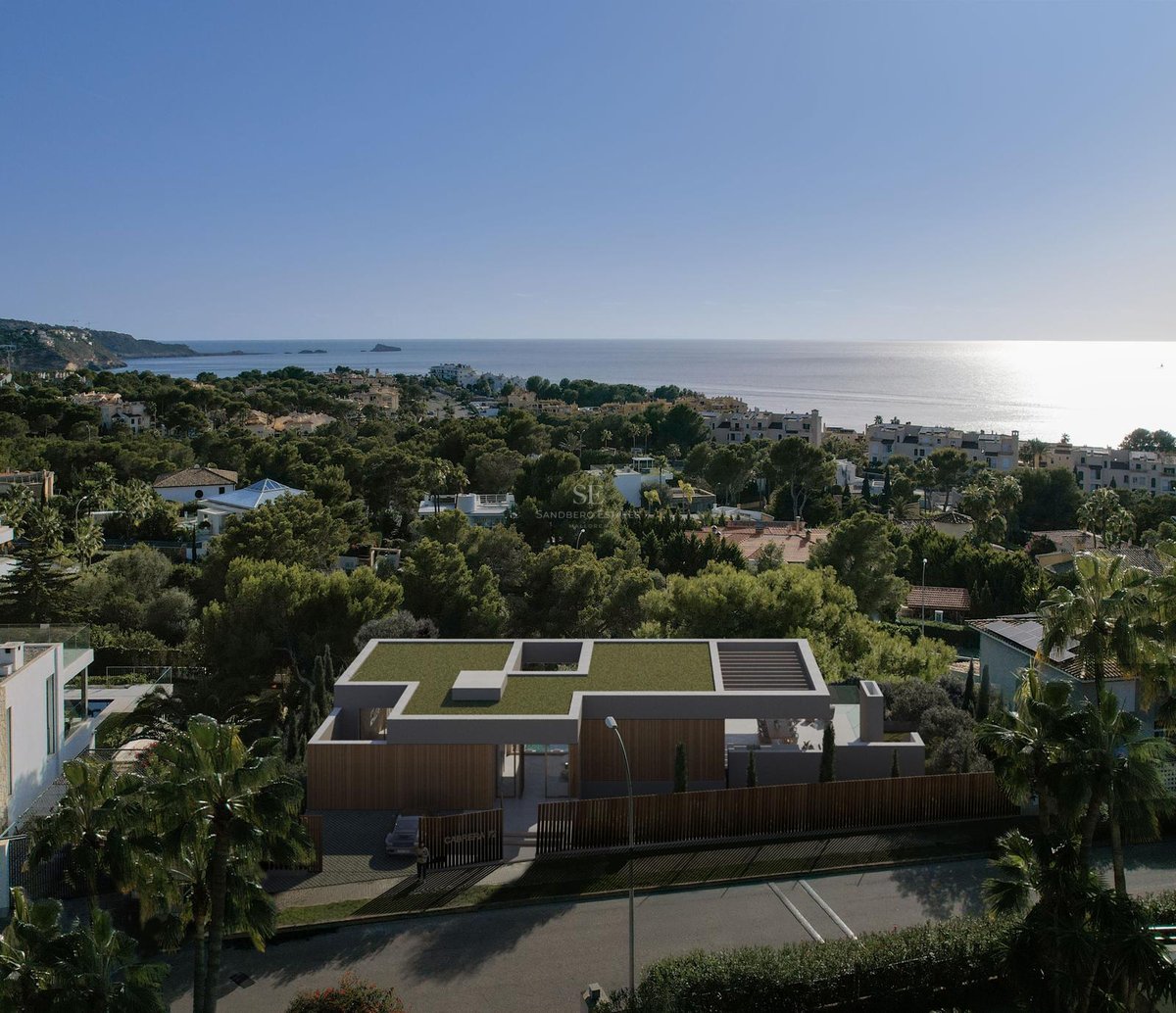Vue aérienne d'une villa contemporaine avec toit végétalisé et façade en bois surplombant la mer Méditerranée.