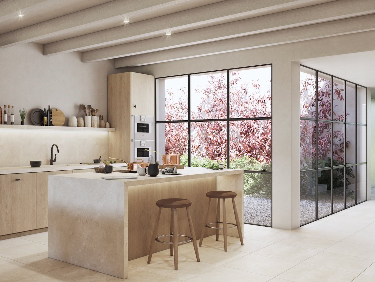 Cuisine moderne avec îlot en pierre et grandes baies vitrées donnant sur un patio privé avec feuillage rouge.