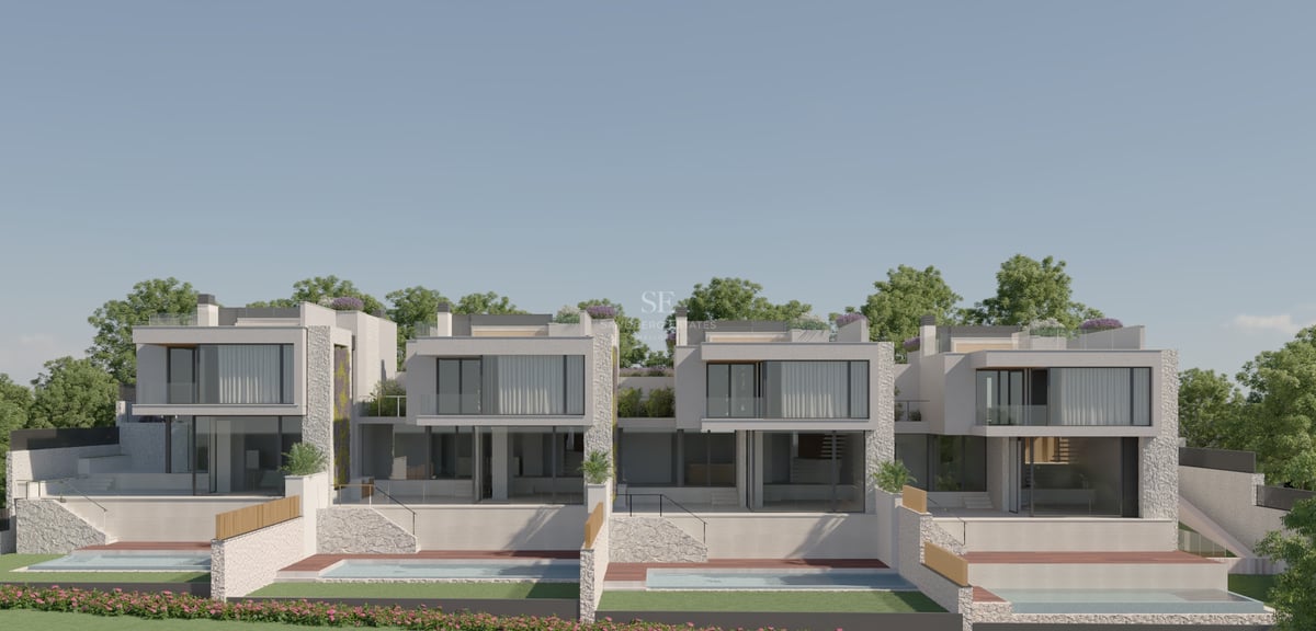 Exterior view of two modern white villas with large glass windows, stone accents, and private swimming pools.