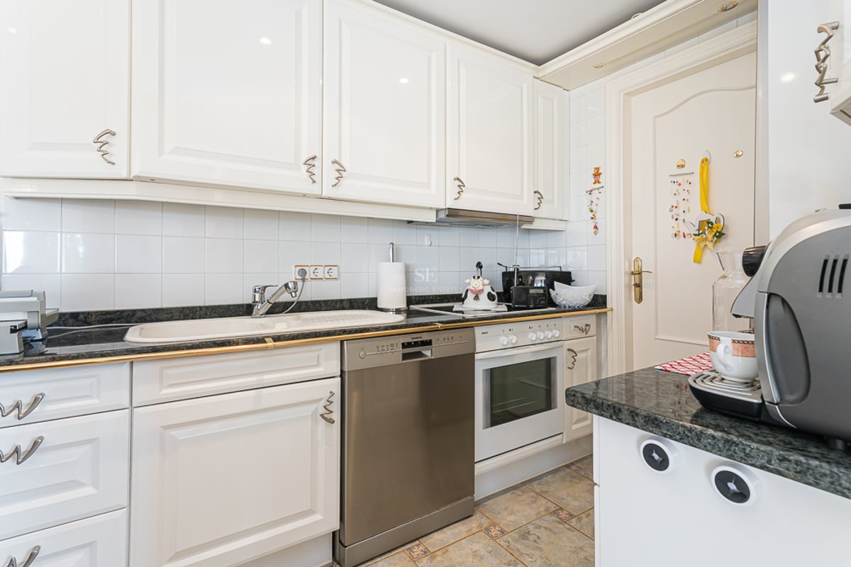 Spacious terrace with pool surrounded by greenery. Modern design, with outdoor furniture and unobstructed views.