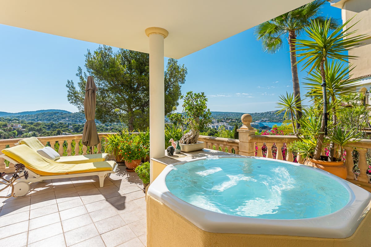 Exterior view of modern villa with infinity pool, lush garden, and expansive terraces. Minimalist architecture and elegant design.