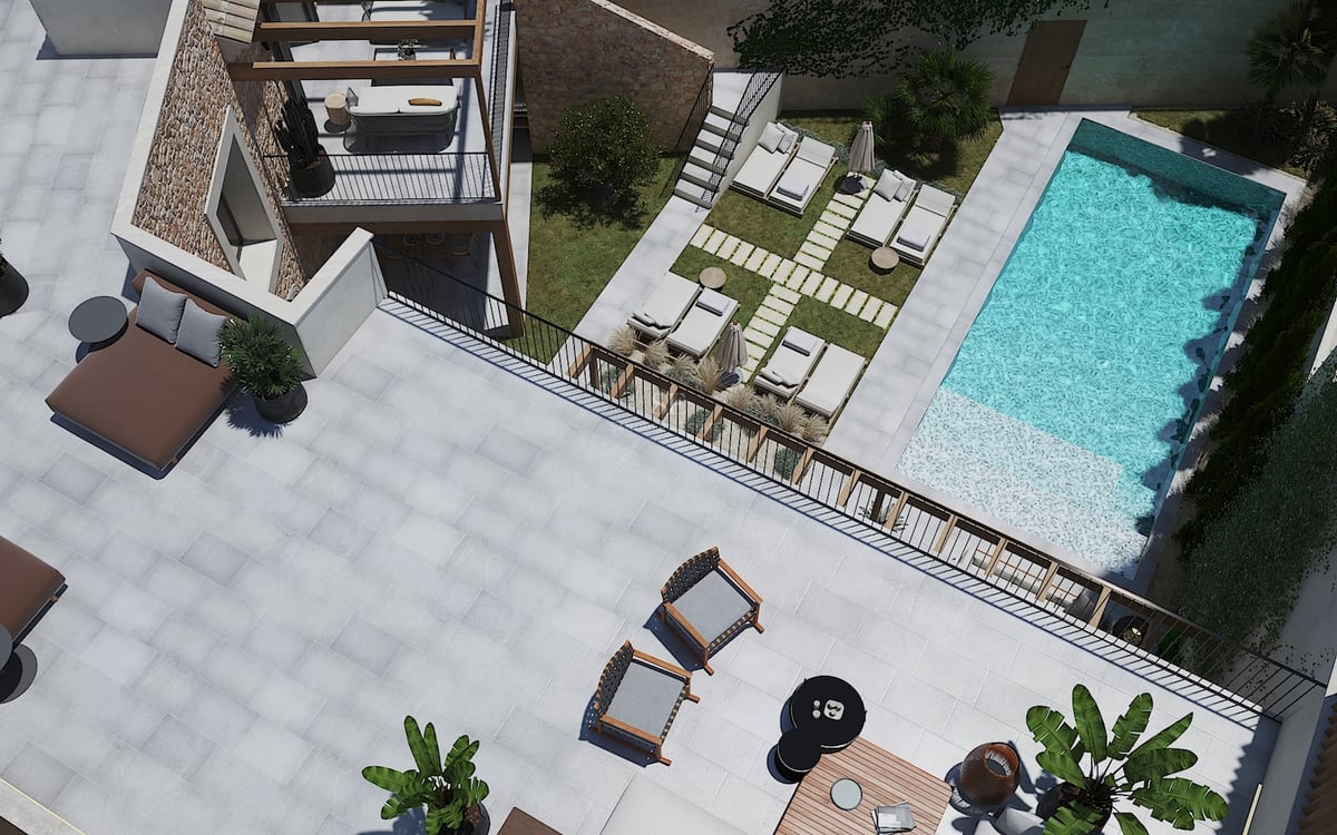 Vue aérienne d'une villa moderne avec piscine turquoise, murs en pierre et grands espaces de détente extérieurs.