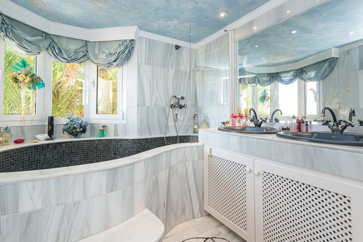 Spacious terrace with infinity pool and panoramic views. Modern design featuring natural stone, wood, and high-end finishes.