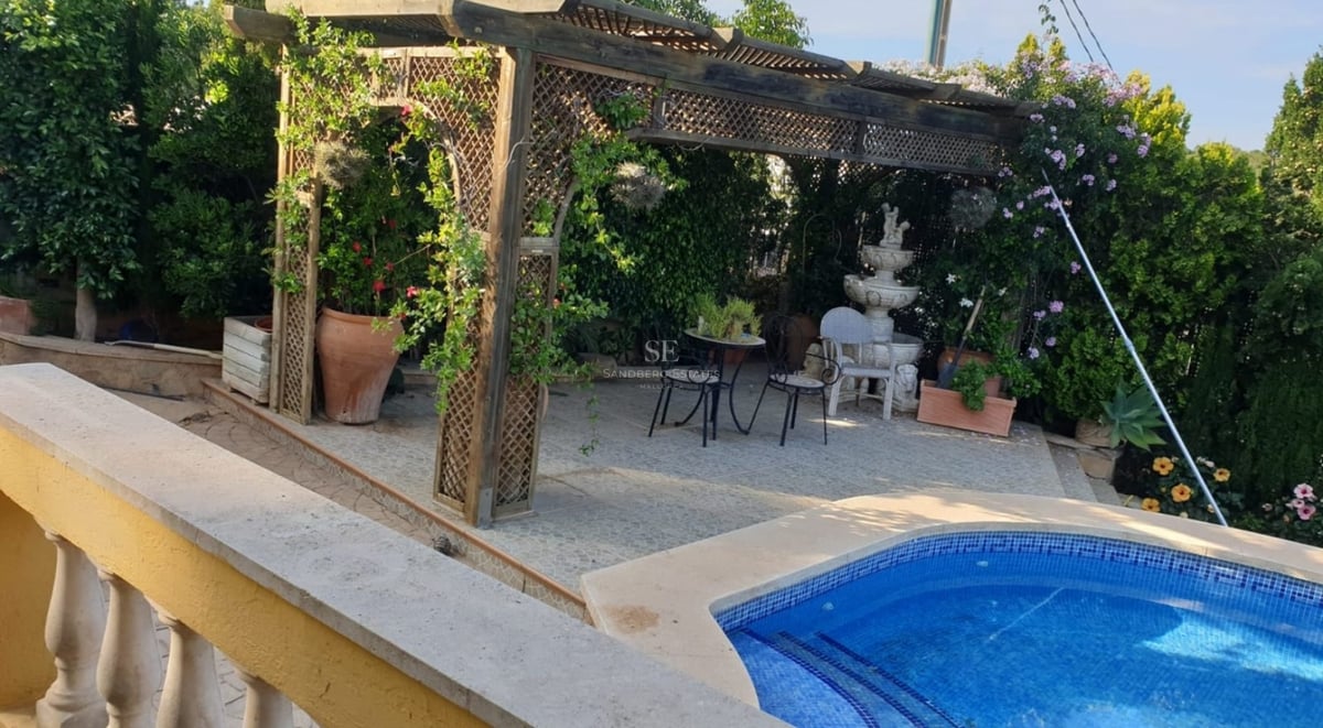 Bright living room with large windows, outdoor pool, minimalist design furniture, and neutral color palette.