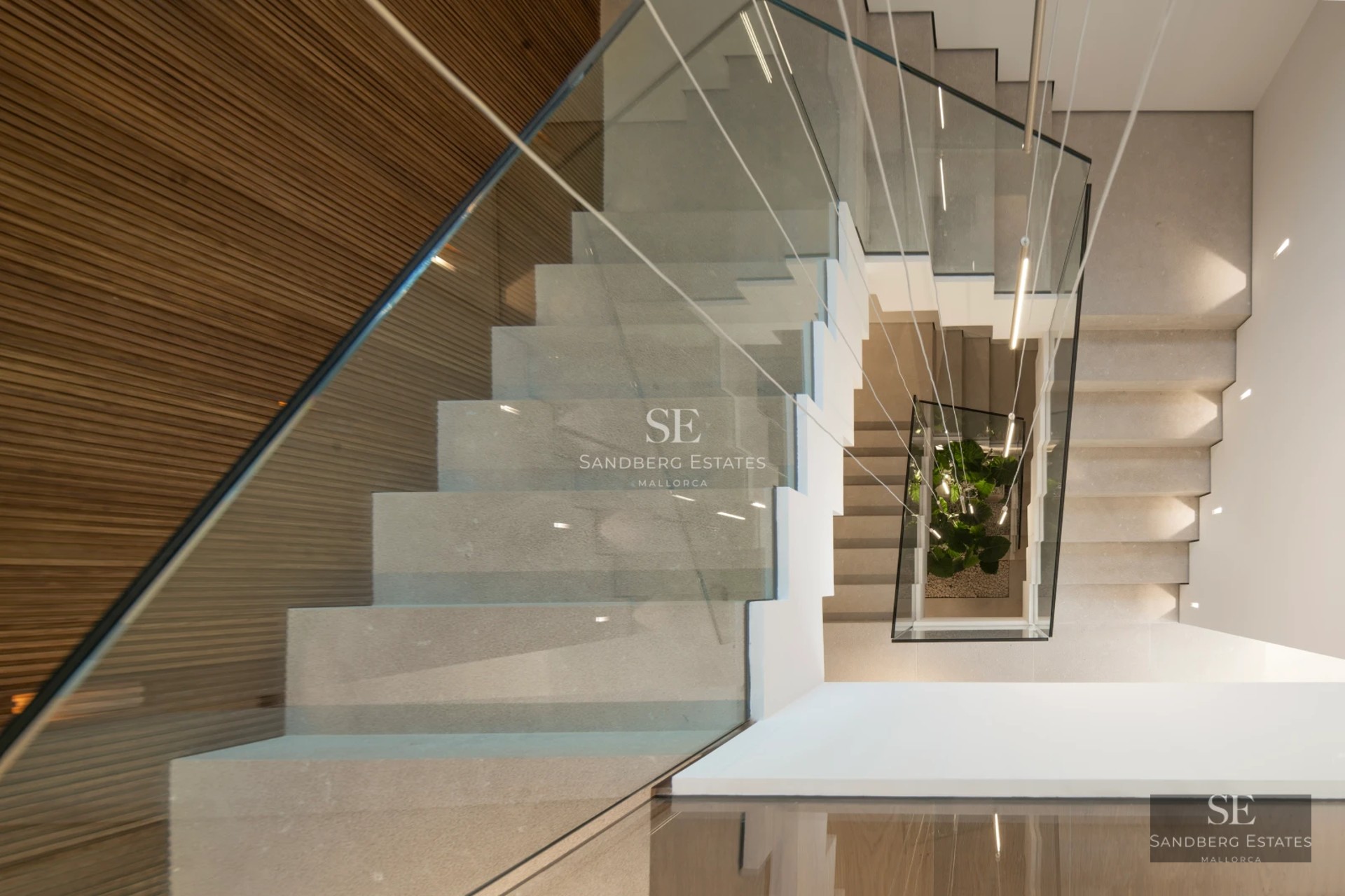 View of modern property with reflective pool and lush garden. Minimalist architecture and large windows.