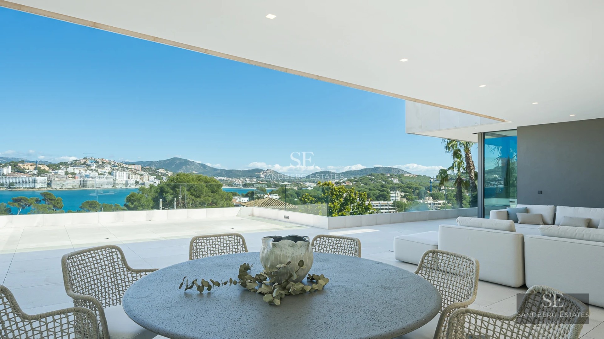 Exterior view of a modern house with a pool, large garden, terraces, and panoramic windows. Minimalist architectural design.