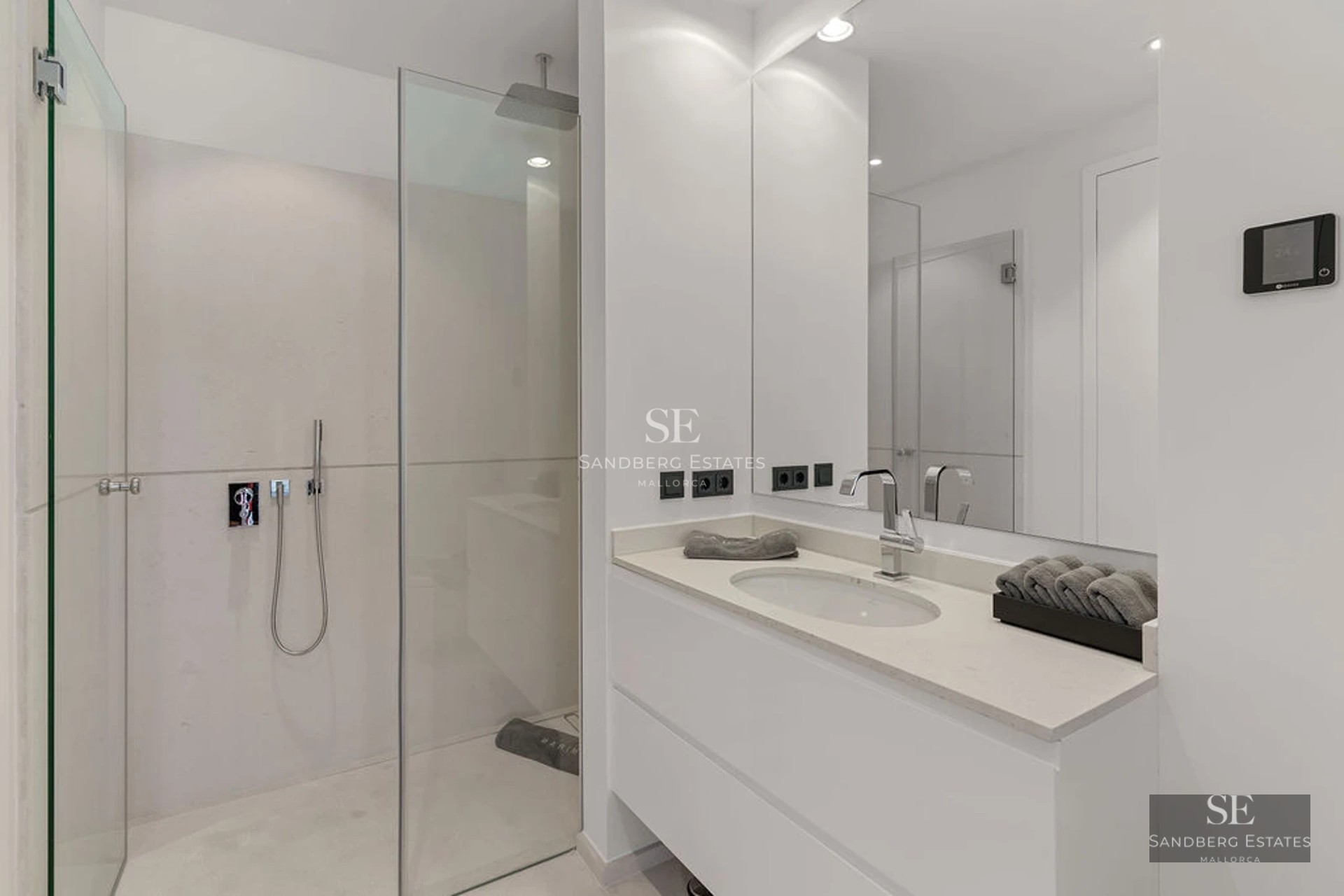 View of a lush garden with impeccable lawn, manicured shrubs and leafy trees, creating a serene and private atmosphere.