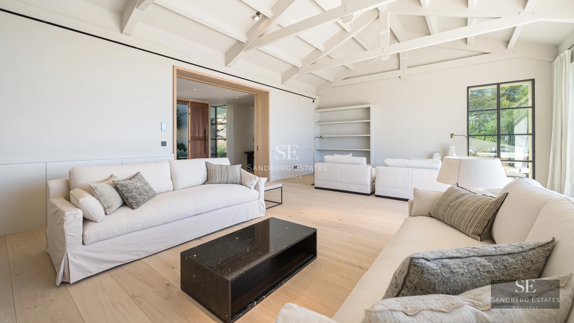 Aerial view of luxury property with infinity pool, lush garden, and modern architectural design. Ambient lighting.