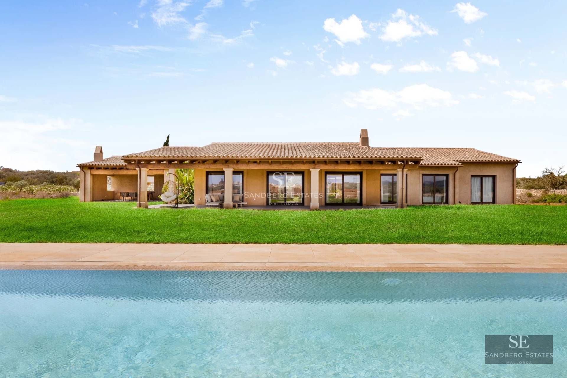 Modern pool view with sleek furniture and lush gardens. Minimalist architecture with large windows and natural lighting.
