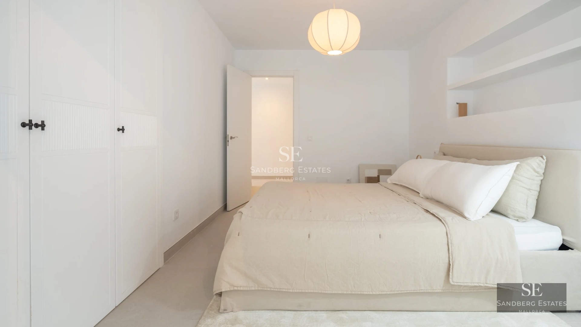 Spacious balcony with sea view. Modern design with glass railing, outdoor furniture, and wooden flooring.