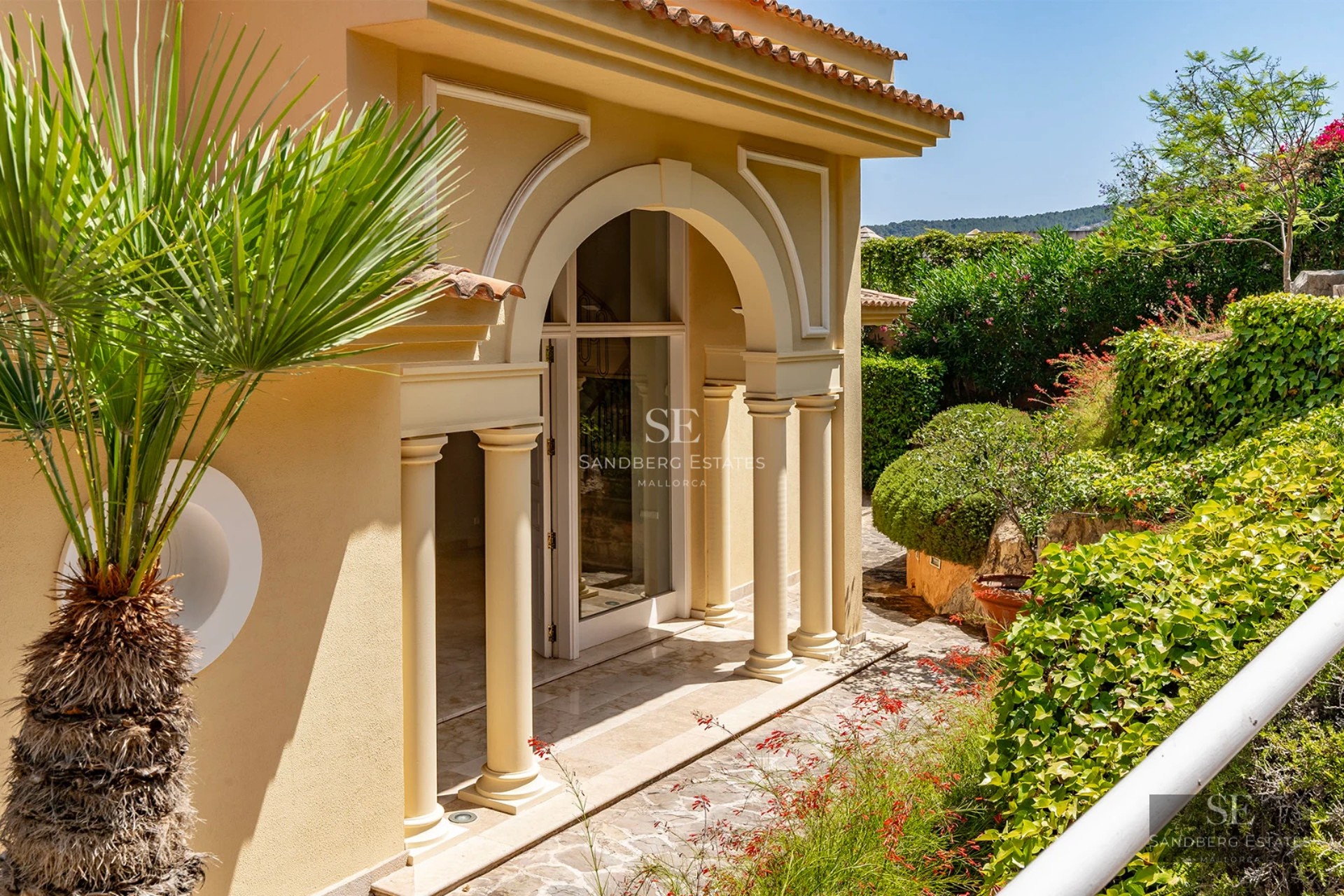 Spacious living room featuring a fireplace, large windows, and panoramic views. Leather sofa, designer rug, and modern decor.