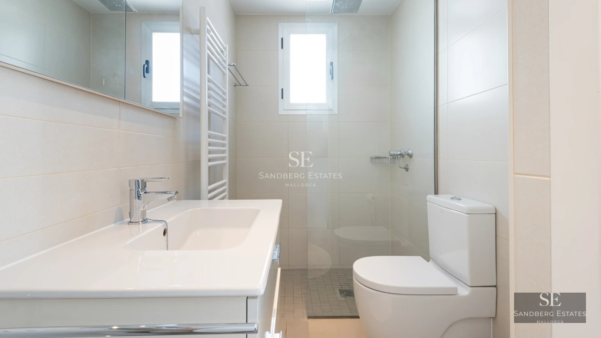 Spacious, bright living room featuring panoramic windows, a modern fireplace, and designer furniture. Stunning sea views.