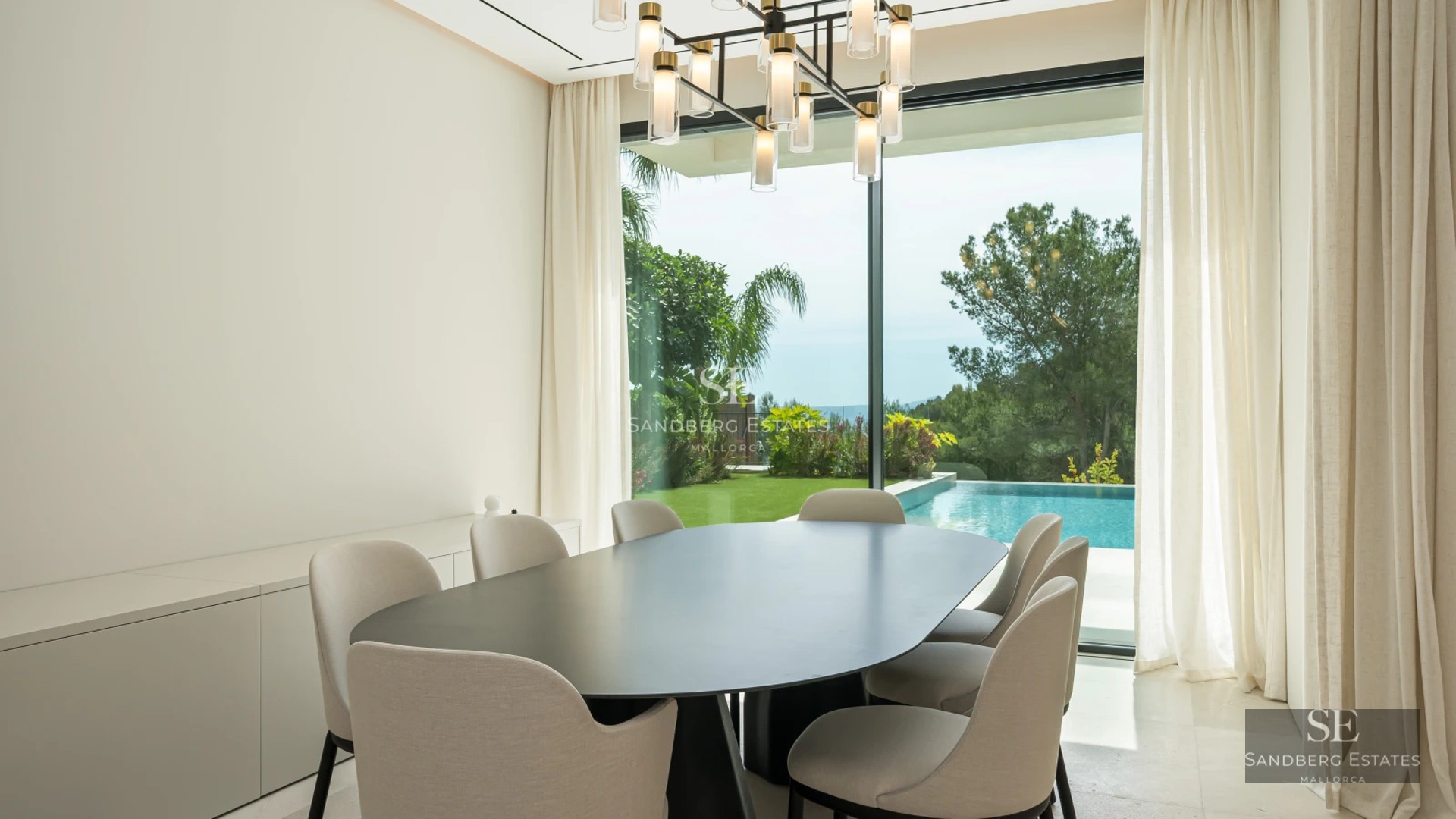 Spacious terrace with infinity pool, sun loungers, and stunning views. Modern design with glass railing.