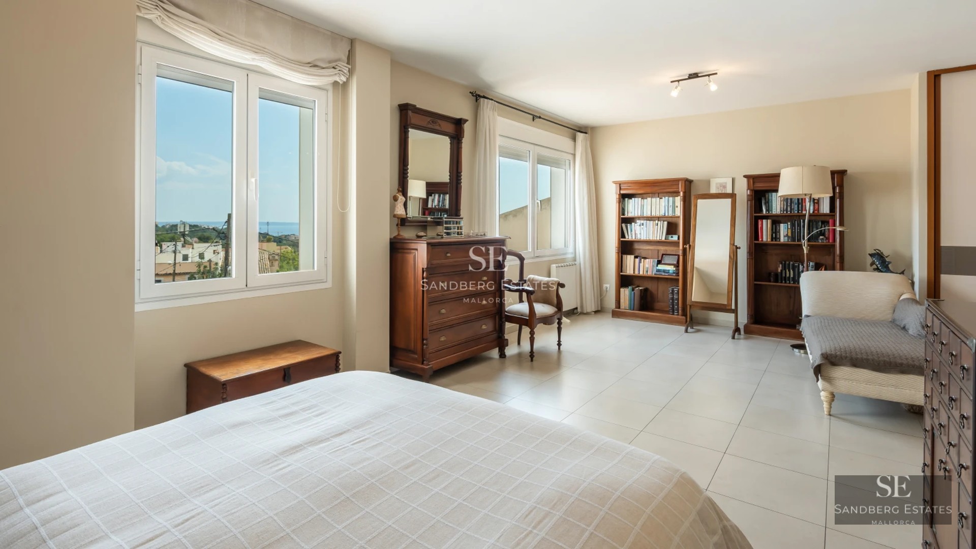 Bright interior with a balcony overlooking the sea. Modern design featuring wood floors, elegant furnishings and abundant natural light.