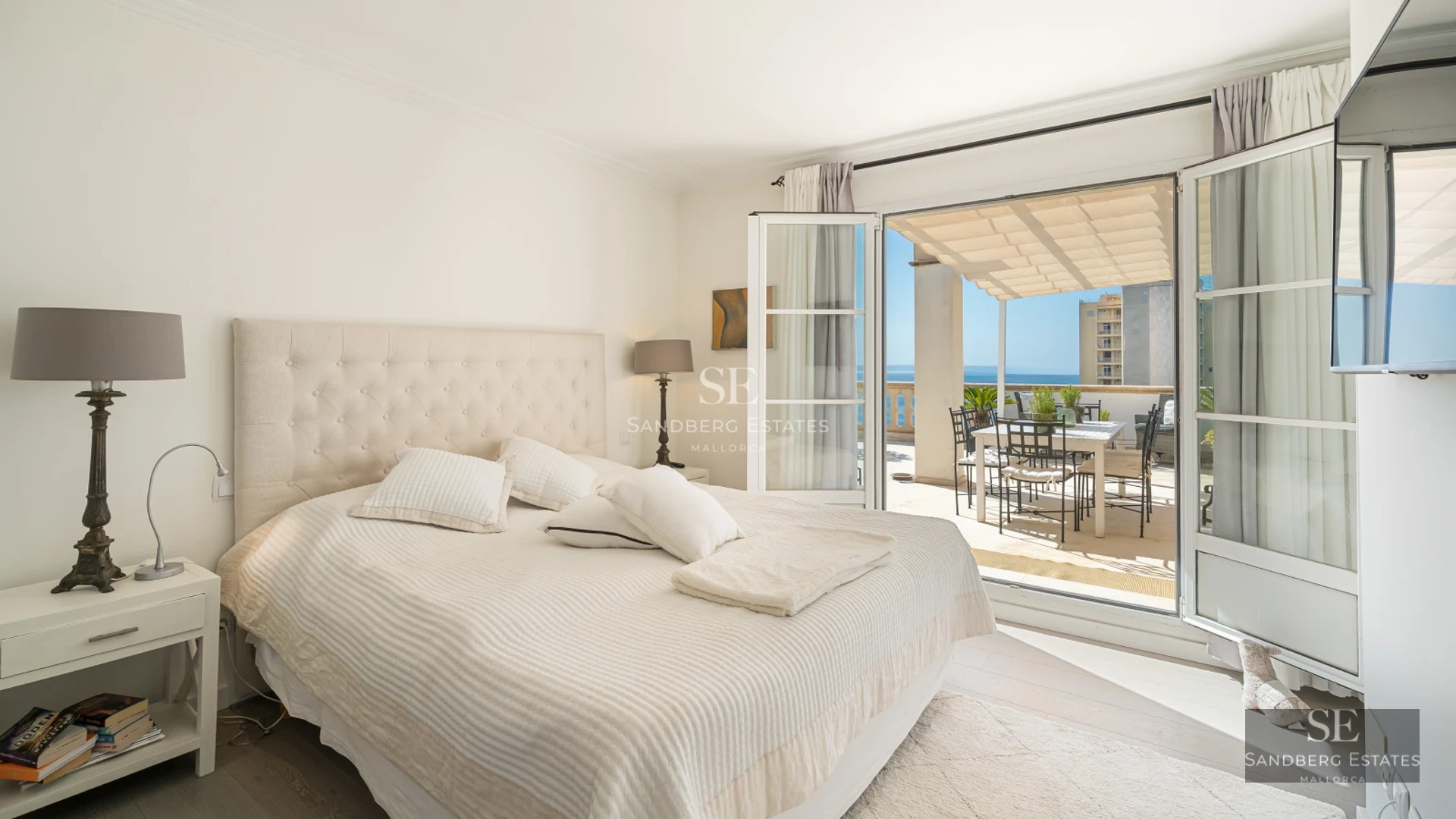 Modern living room with large windows, abundant natural light, and stunning views. Designer furniture and high-quality finishes.