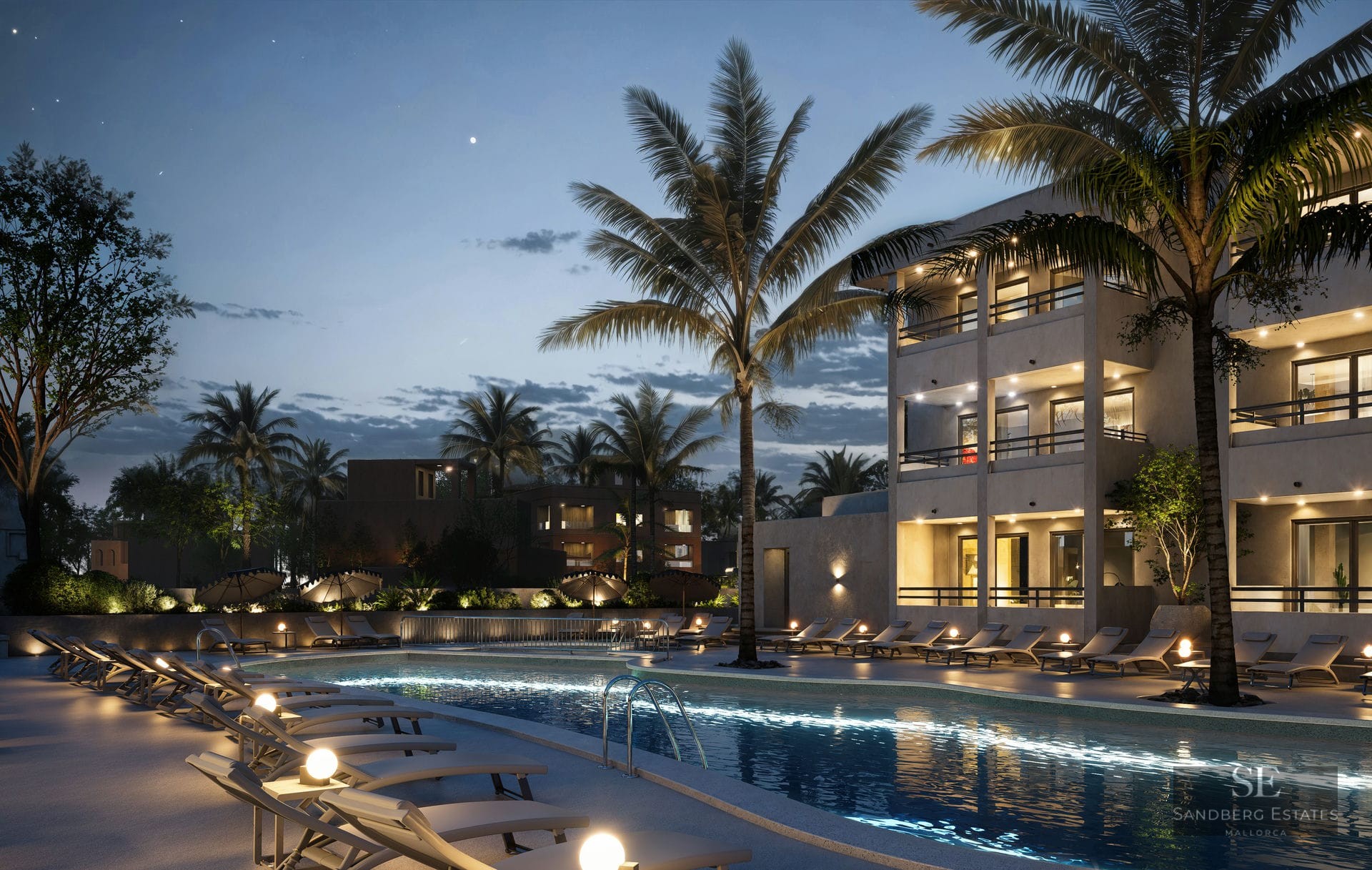 Illuminated swimming pool surrounded by sun loungers and palm trees under a twilight sky next to a modern building.