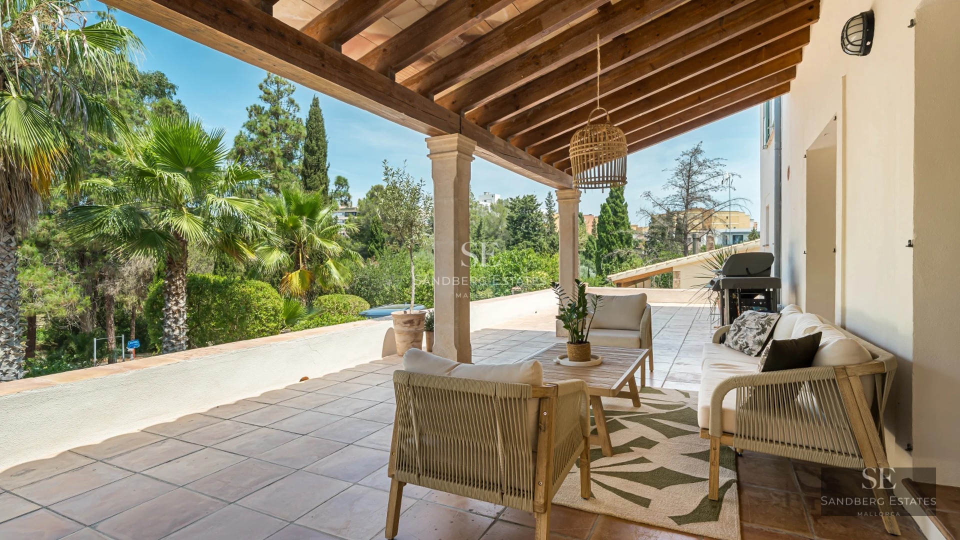 Aerial view of a luxury home with infinity pool, immaculate garden, spacious terrace and modern architectural design.