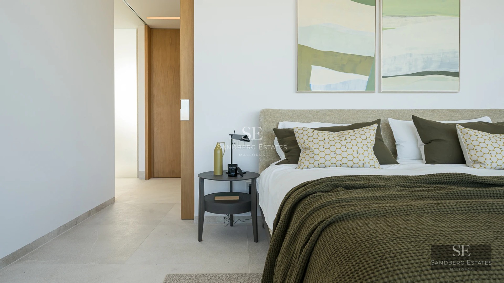 Spacious living room with large windows, modern fireplace, and garden view. Designer furniture and abundant natural light.