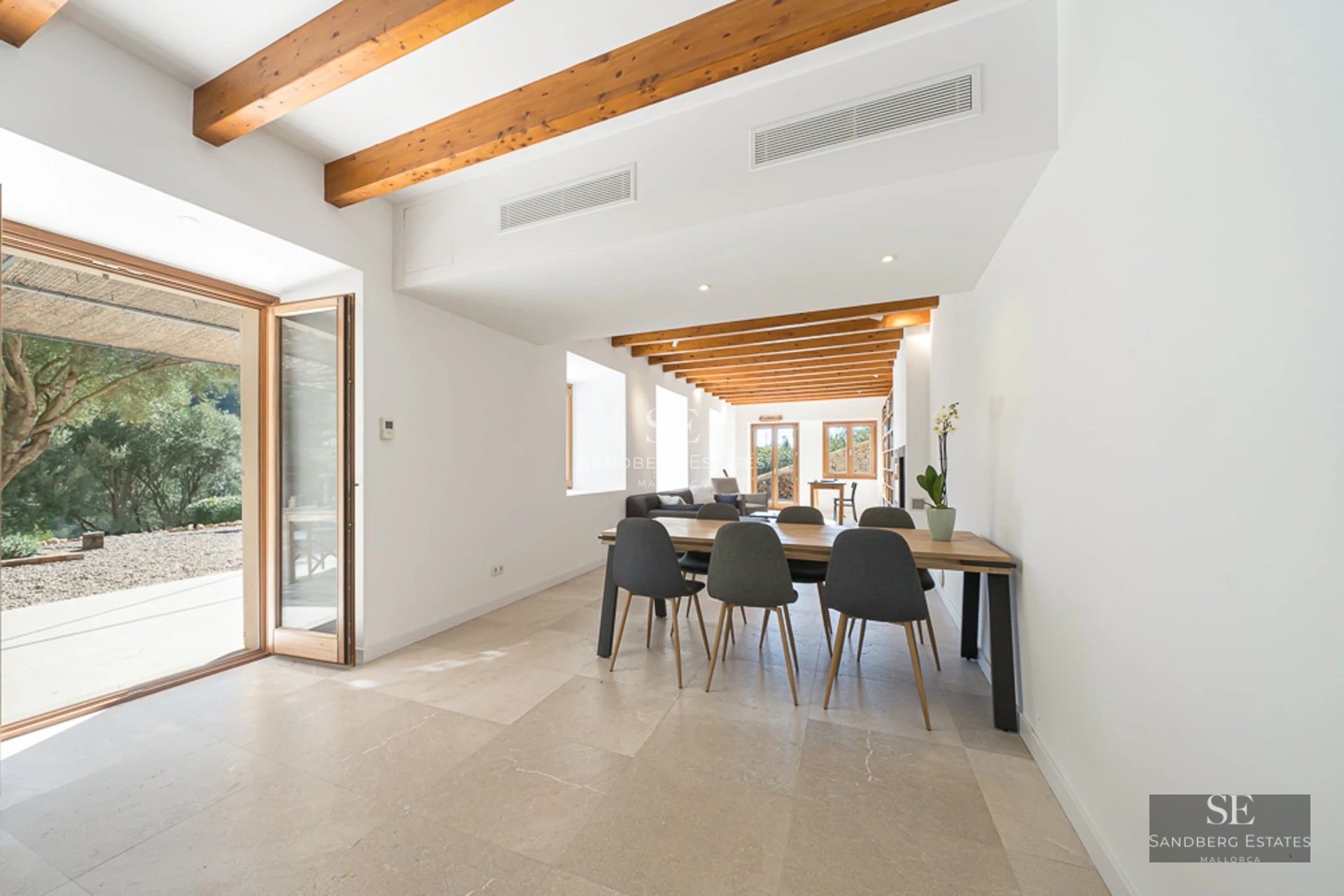 Exterior view of a modern villa with pool, expansive terraces, minimalist design, and lush greenery. White facade and large windows.