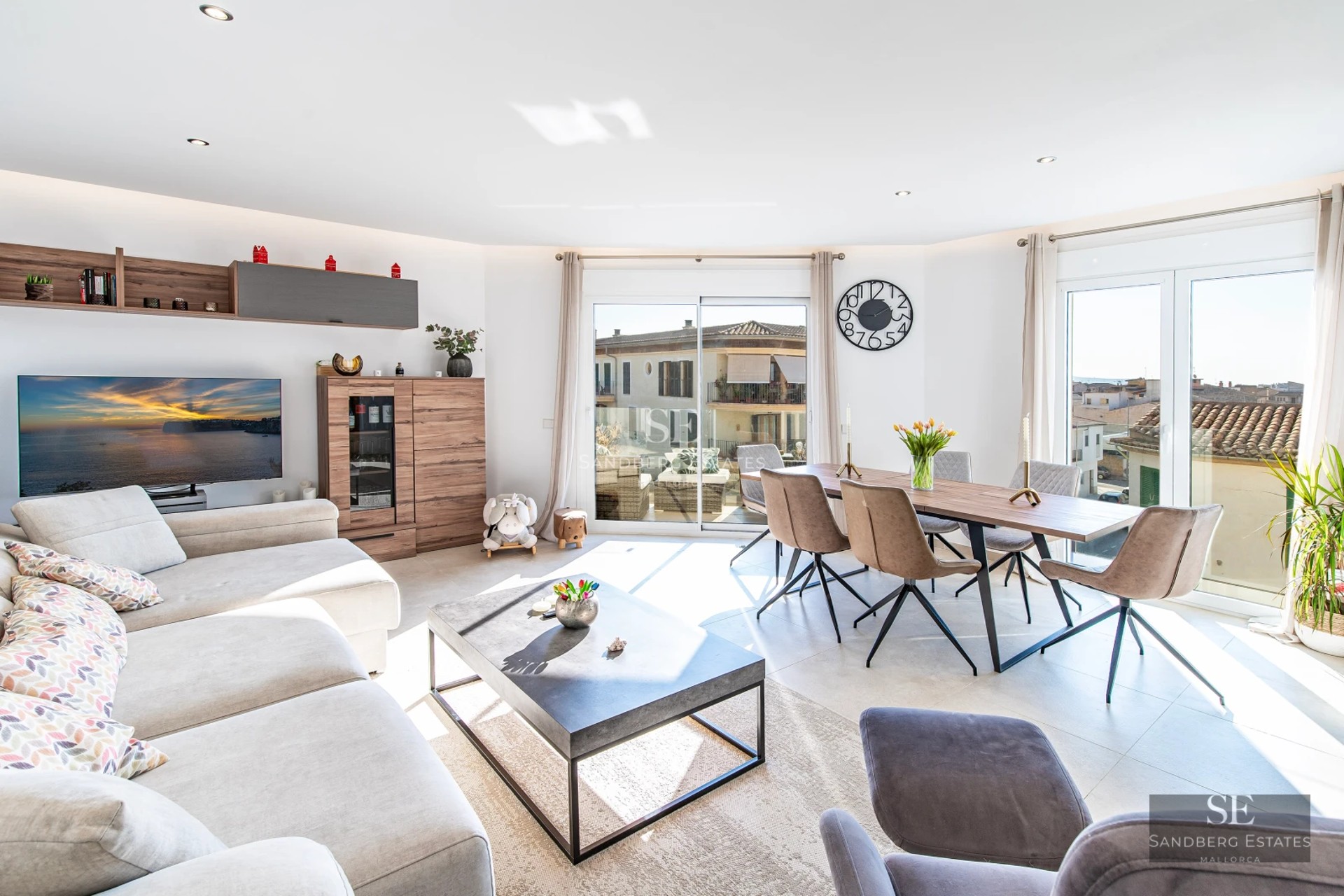 Spacious living room with floor-to-ceiling windows, minimalist furniture, neutral color palette, and access to a terrace with views. Bright and contemporary design.