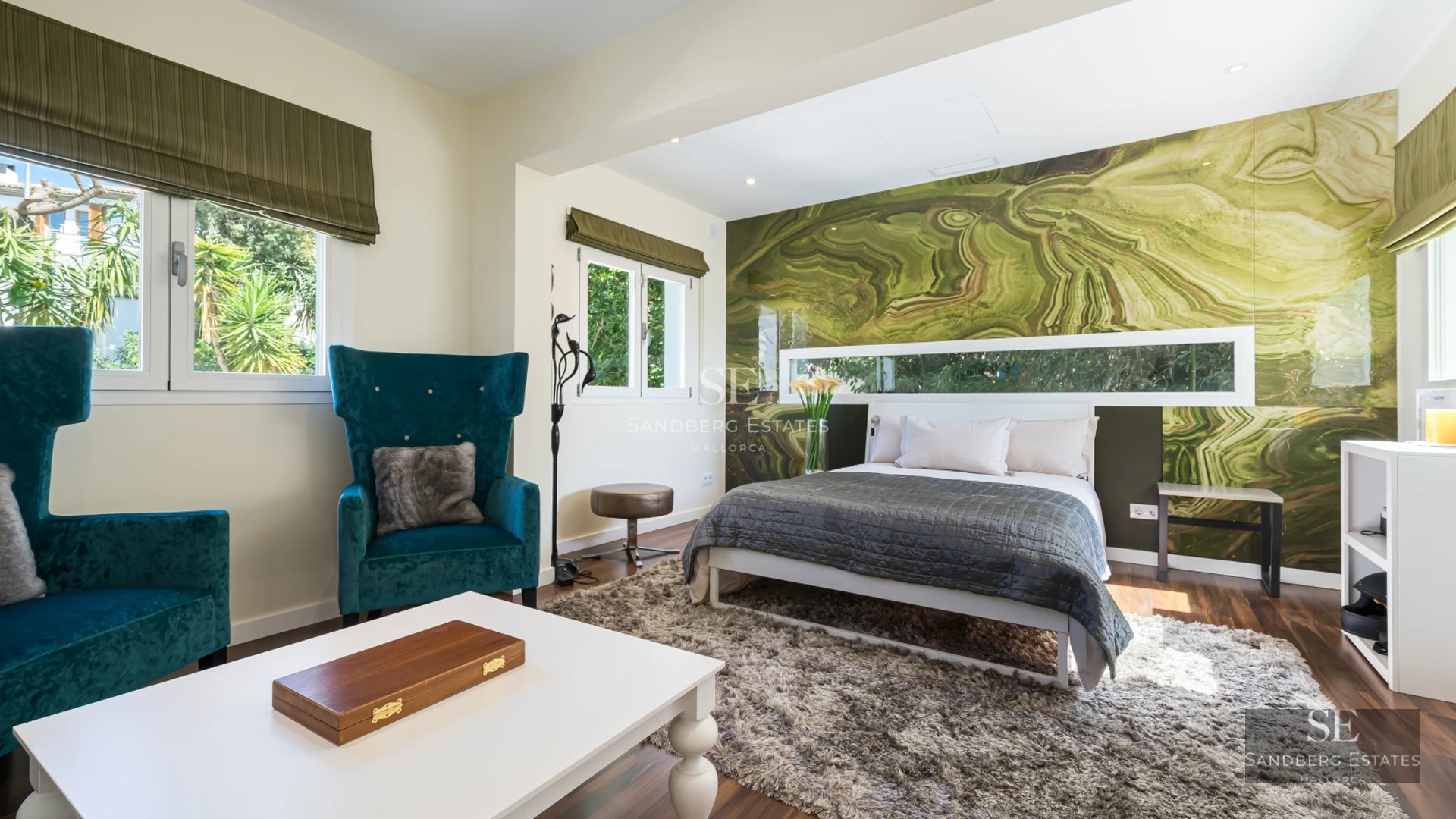 Exterior view of a modern villa featuring a pool, manicured garden, and large windows illuminating the facade. Minimalist and elegant design.