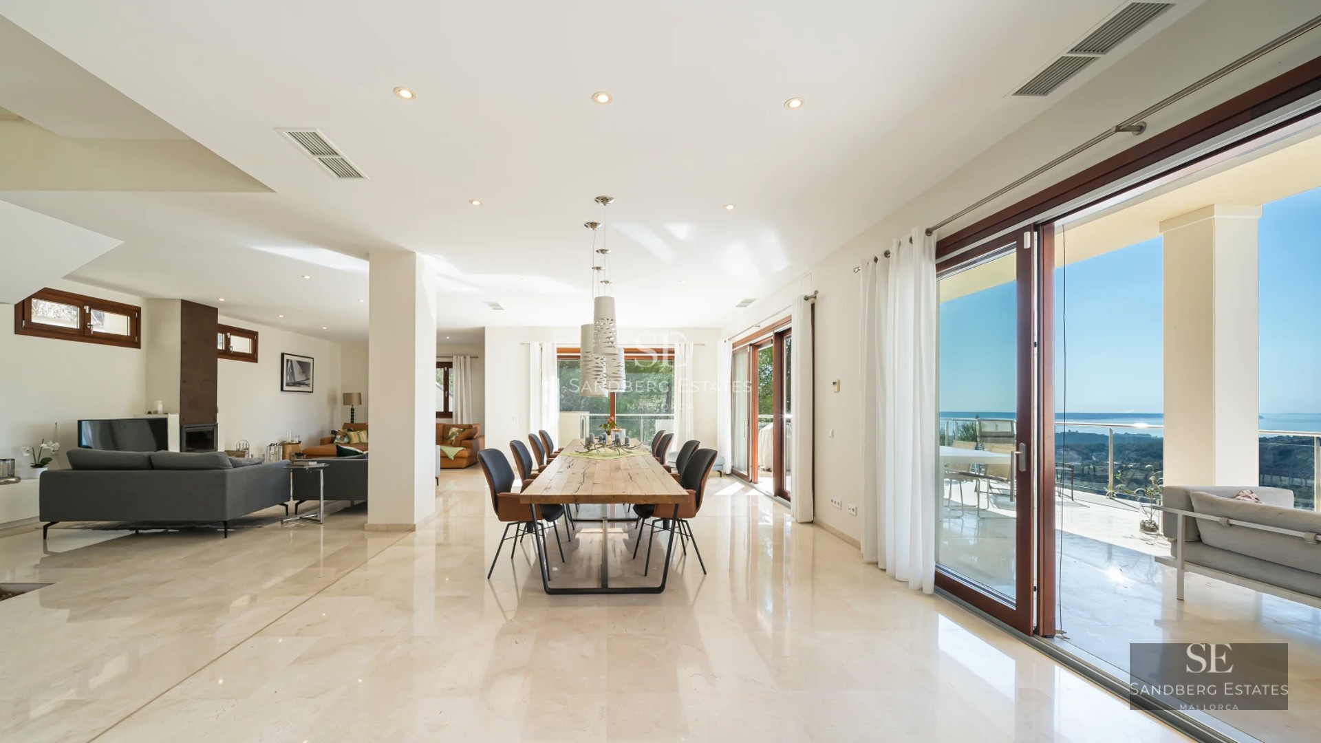 Expansive terrace featuring an infinity pool and ocean views. Modern architecture, stylish outdoor furniture, and lush greenery.