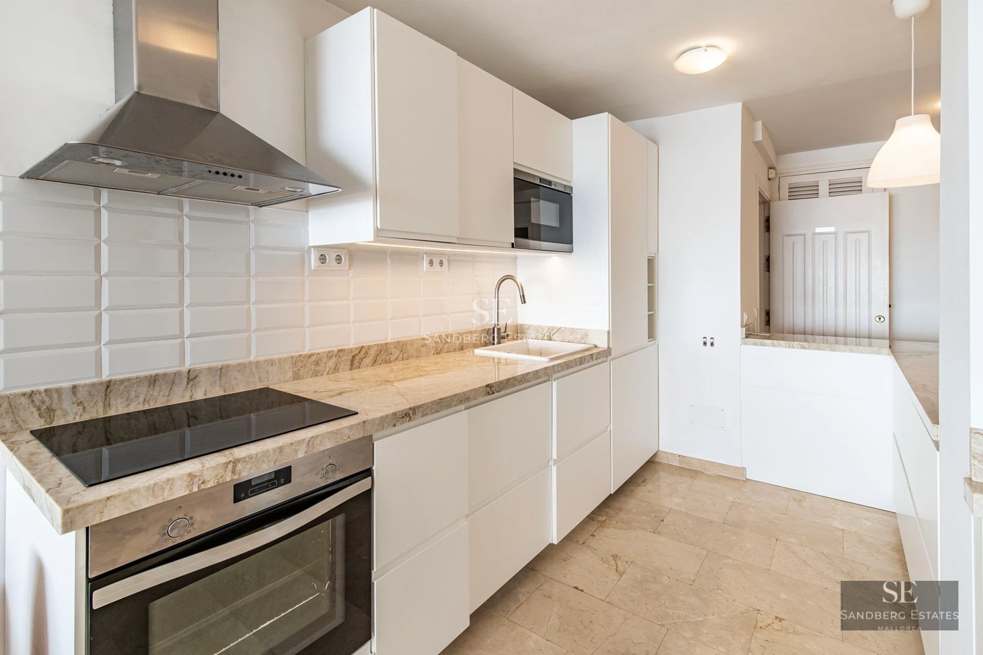 View of infinity pool with loungers, modern architecture, and gardens. Luxurious house with large windows and soft lighting.