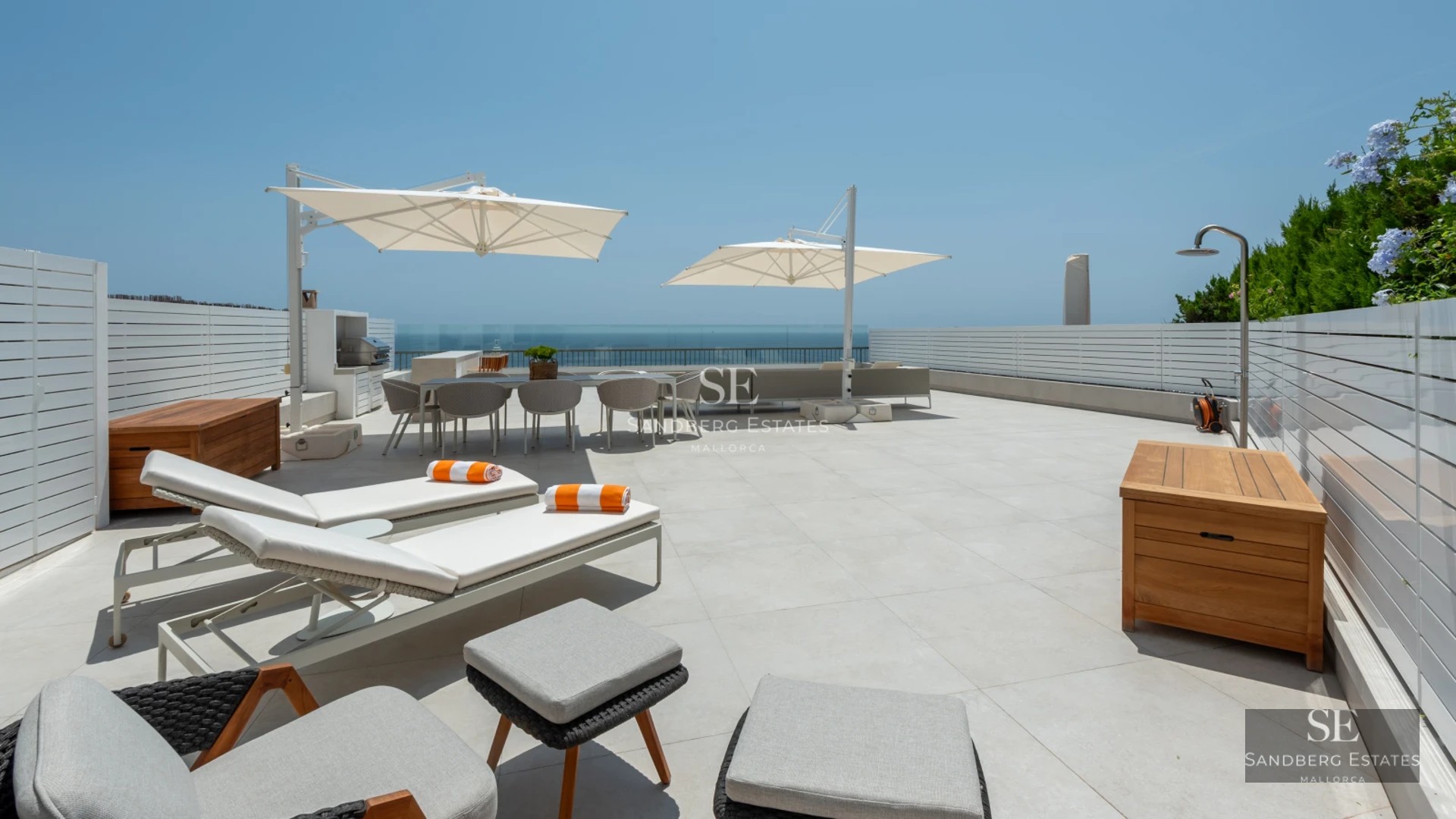 Expansive terrace featuring an infinity pool and panoramic views. Modern design with loungers and stylish outdoor furniture.