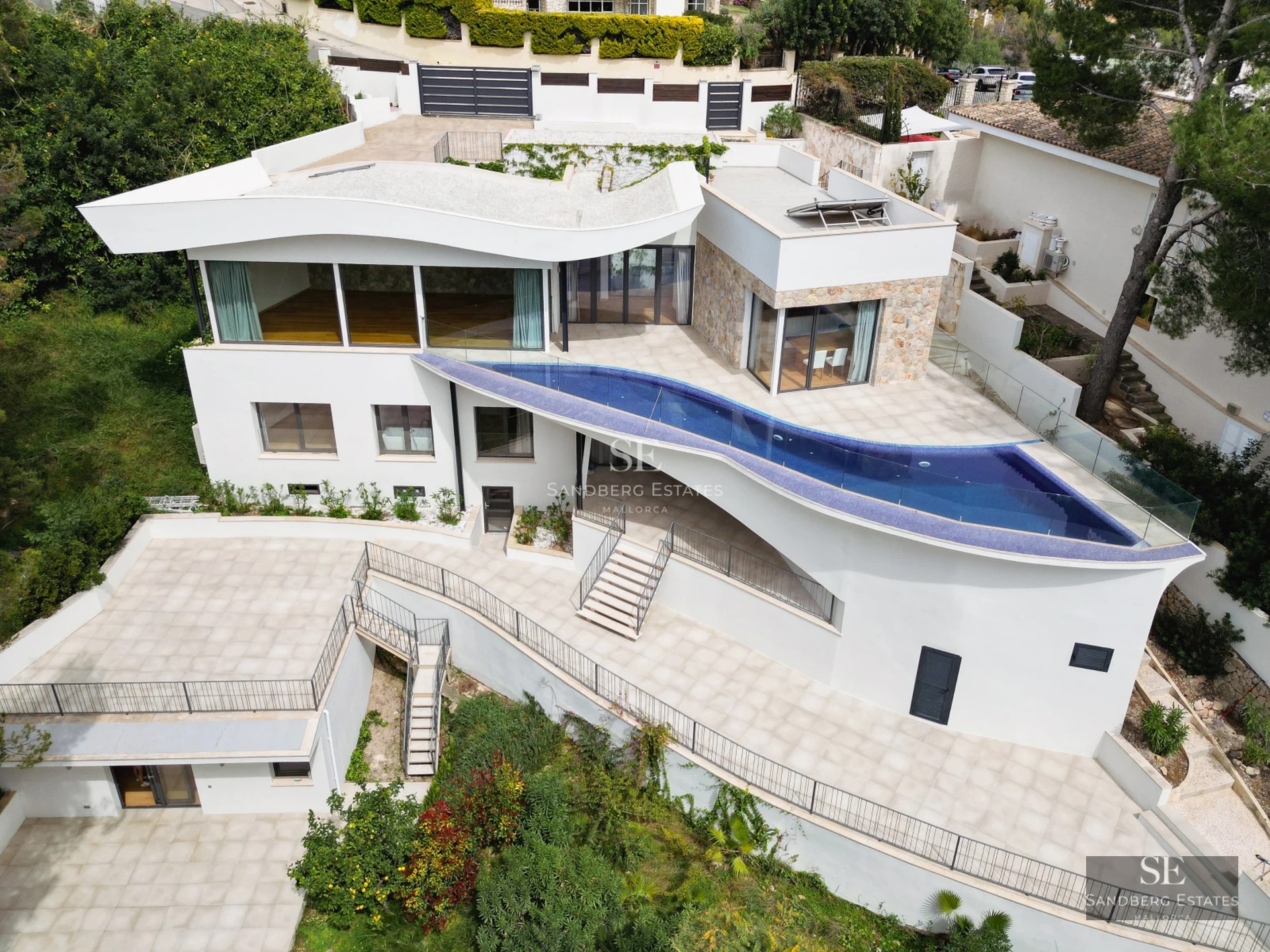 Spacious balcony with sea view. Modern design, glass railing, wood flooring. Minimalist outdoor furniture.