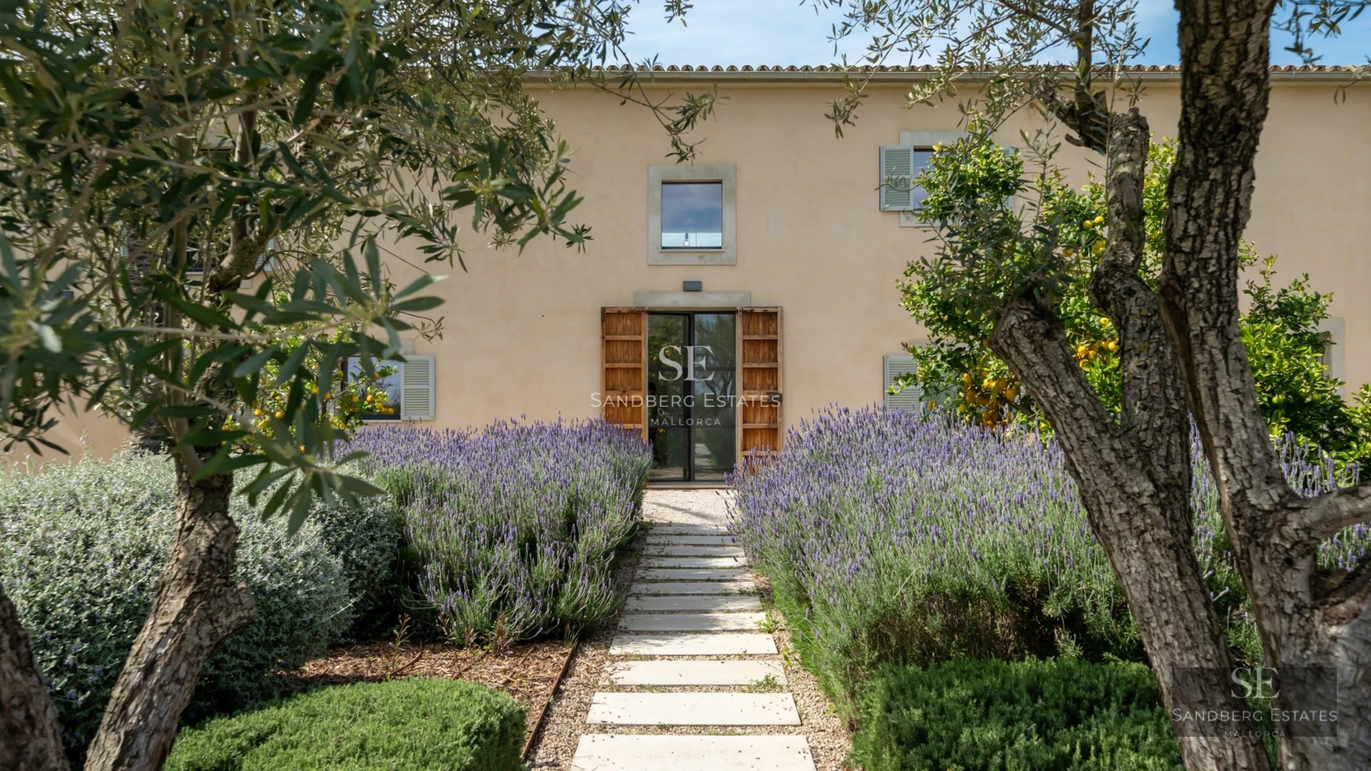 Exterior view of a modern villa with an infinity pool, surrounded by lush gardens and spacious terraces. Minimalist architectural design.
