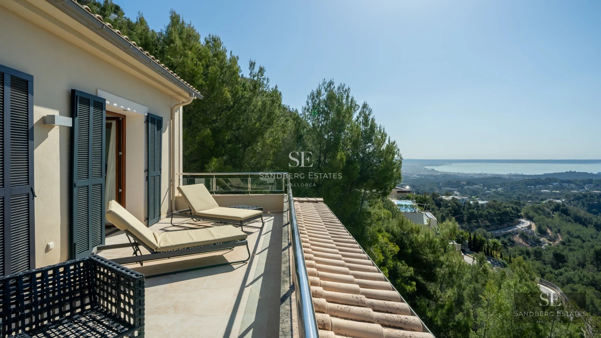 Spacious living room with panoramic windows, light wood floors, modern fireplace, and designer furniture. Sea view and balcony.