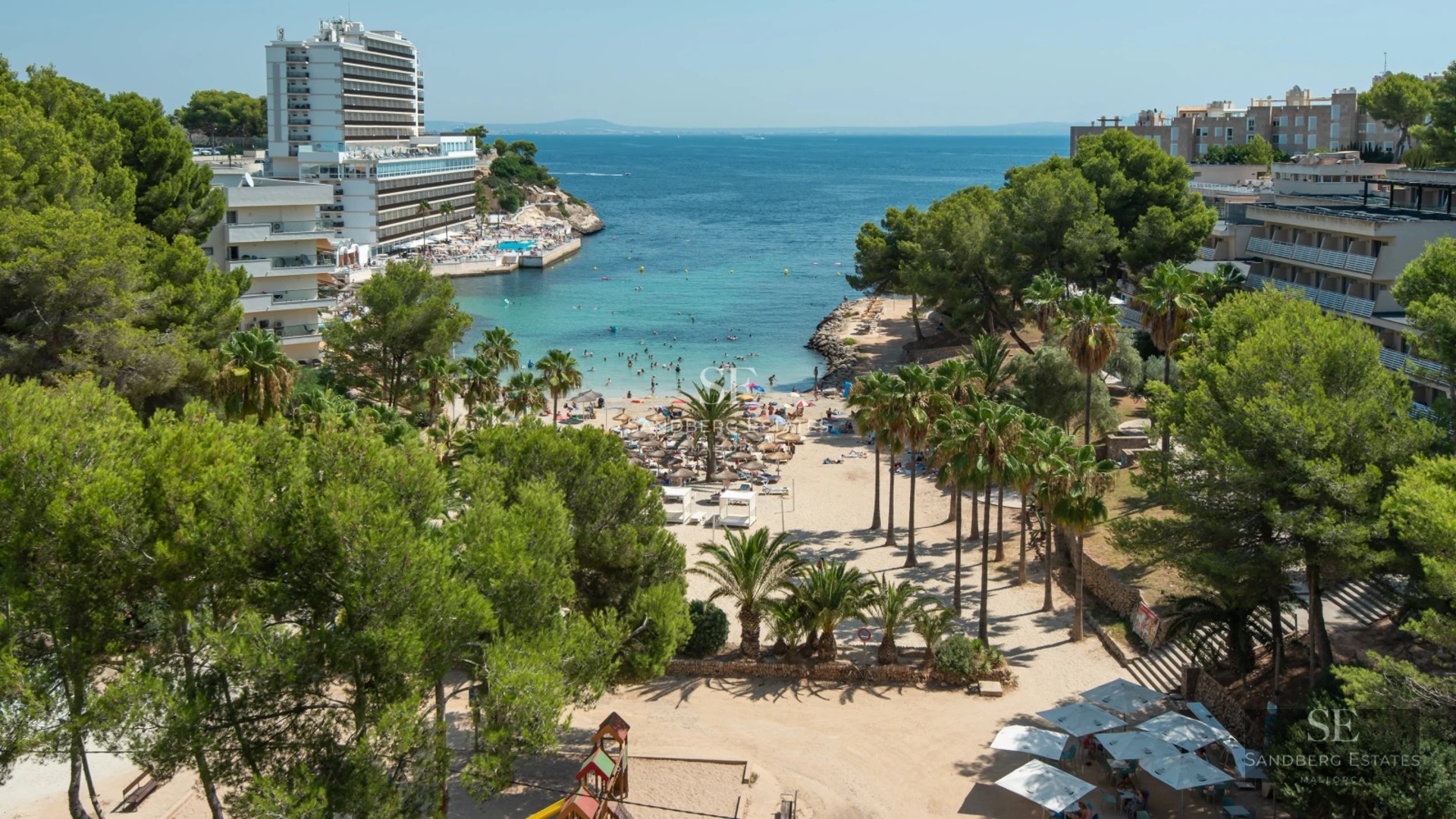 Spacious balcony with sea view, designer furniture, glass railing. Elegant outdoor space with natural light.