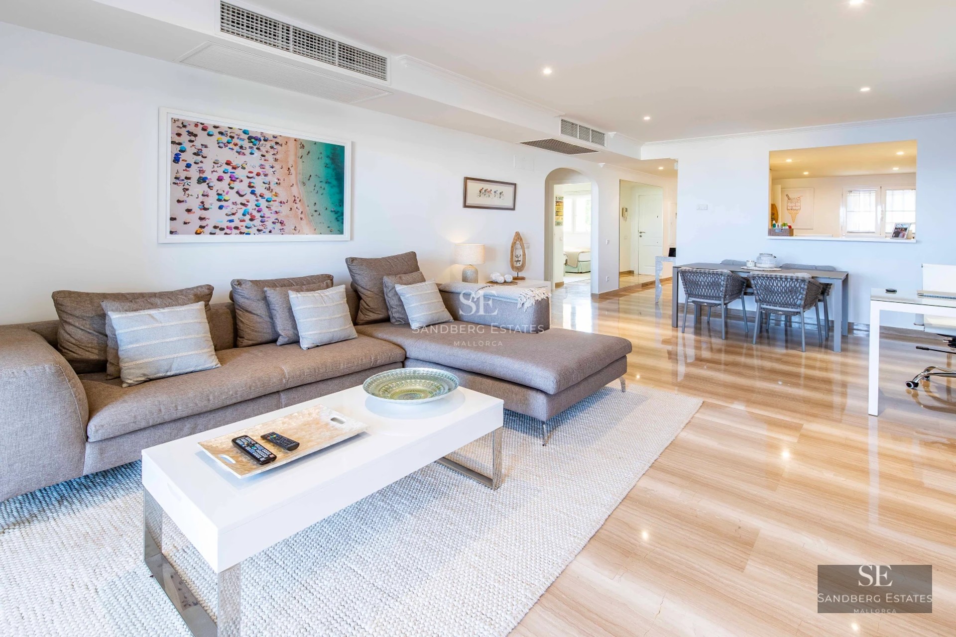 Spacious terrace with pool, sun loungers, and umbrellas. Panoramic views of the garden and blue sky. Modern and minimalist architecture.