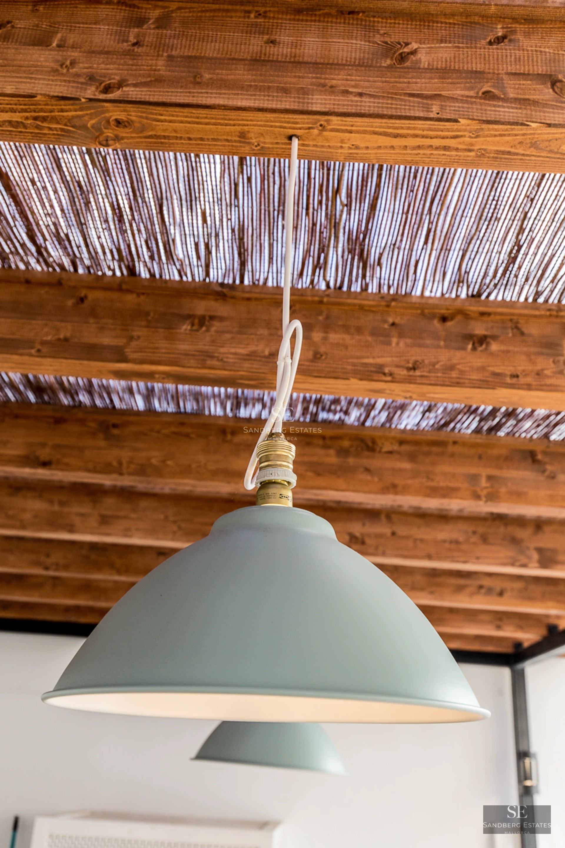 View of the pool and terrace with sun loungers. Modern architecture with large windows and lush vegetation. Luxurious exterior design.