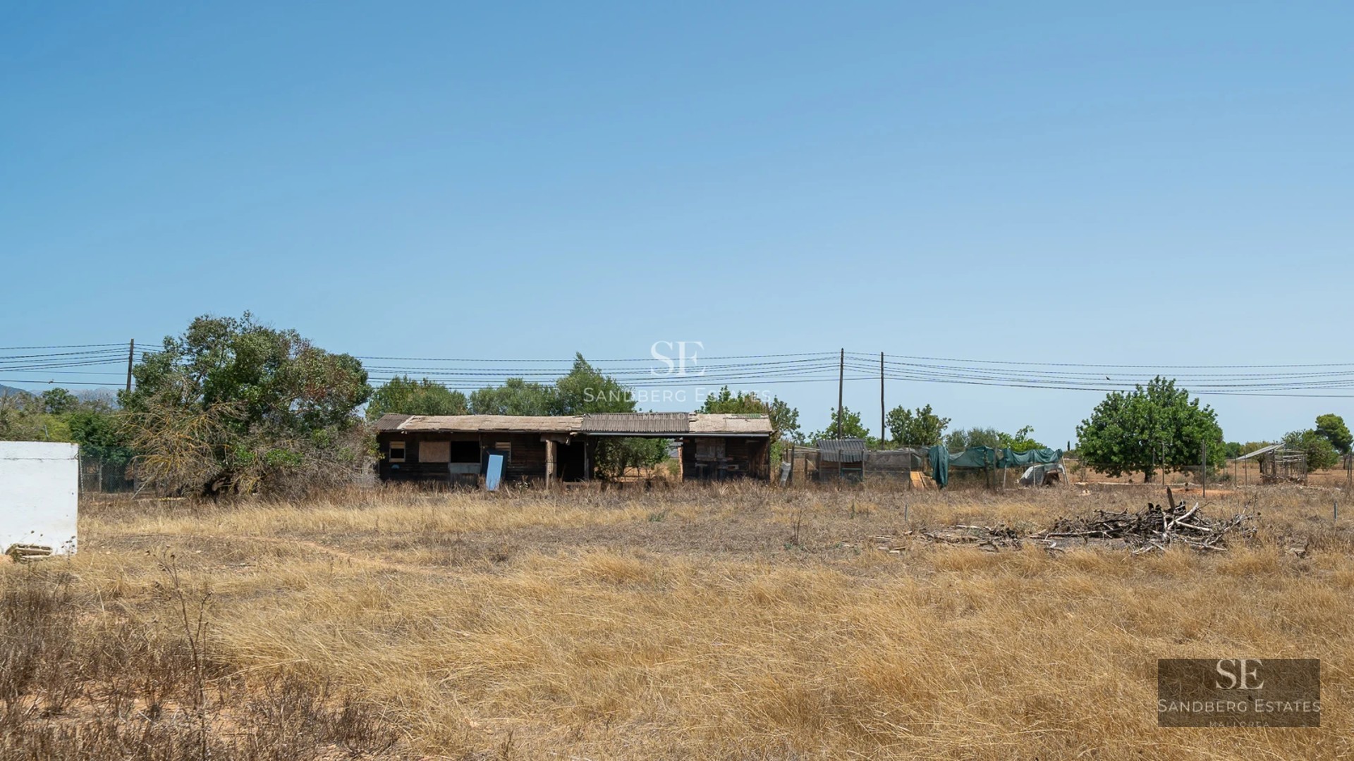 Large balcony with sea view, glass railing, modern furniture. Bright and minimalist interior visible.
