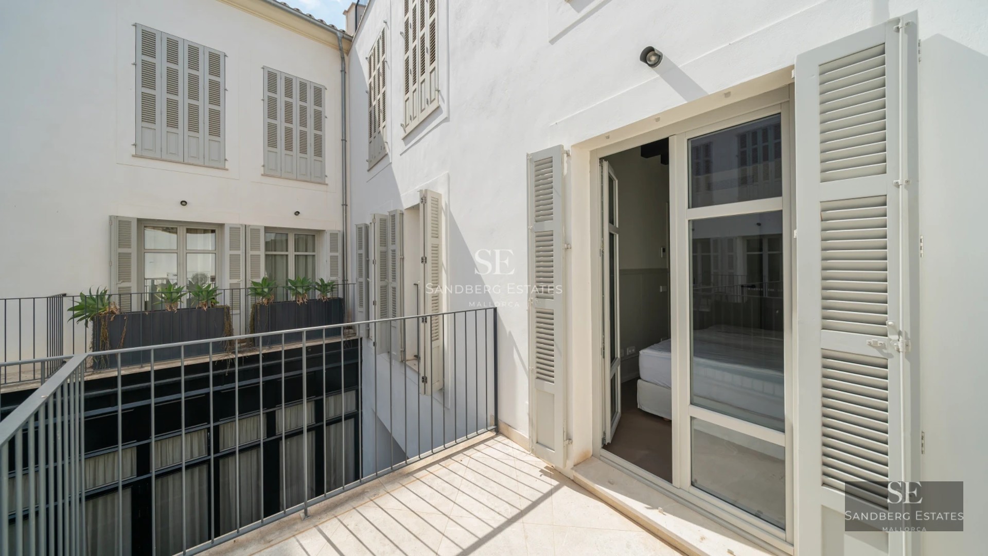 Exterior view of a modern villa with a pool, manicured garden, and minimalist architecture featuring large windows.