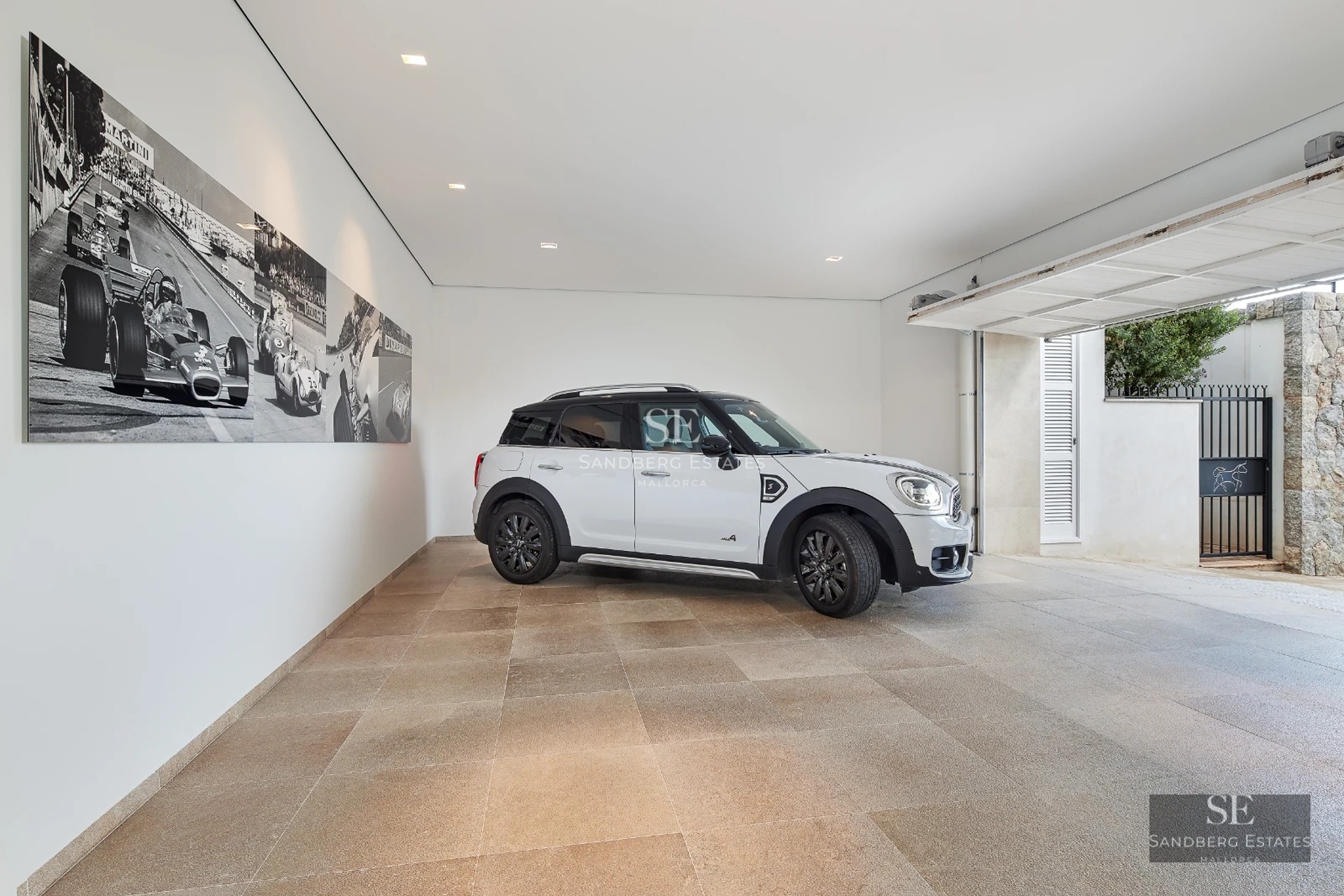 View of infinity pool with terrace, sun loungers, and lush vegetation. Modern architecture with large windows.