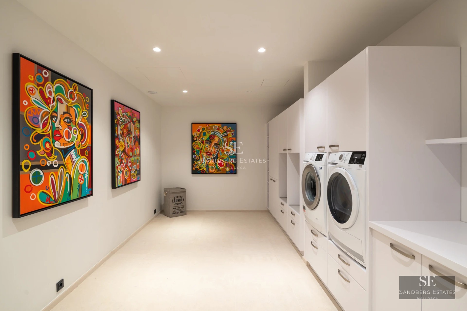 View of infinity pool with glass edge, stylish outdoor living area, and modern architecture with large windows.