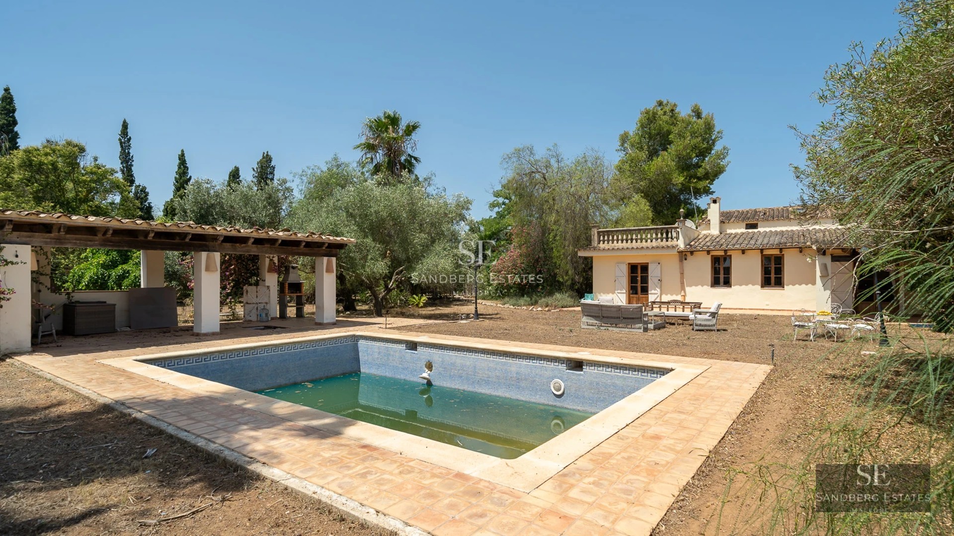 Spacious terrace with pool, sun loungers, and sea view. Modern design featuring a white facade and large windows.