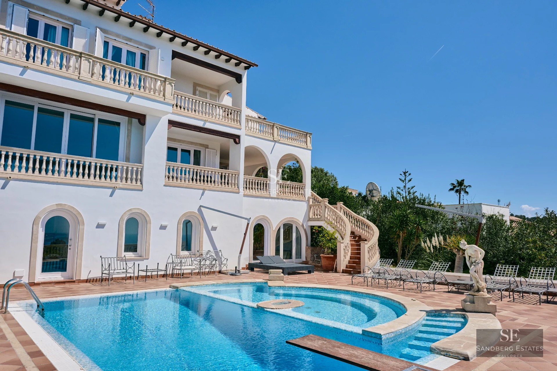 Expansive terrace with infinity pool and panoramic views. Modern design with wood flooring and elegant furniture. Warm ambient lighting.